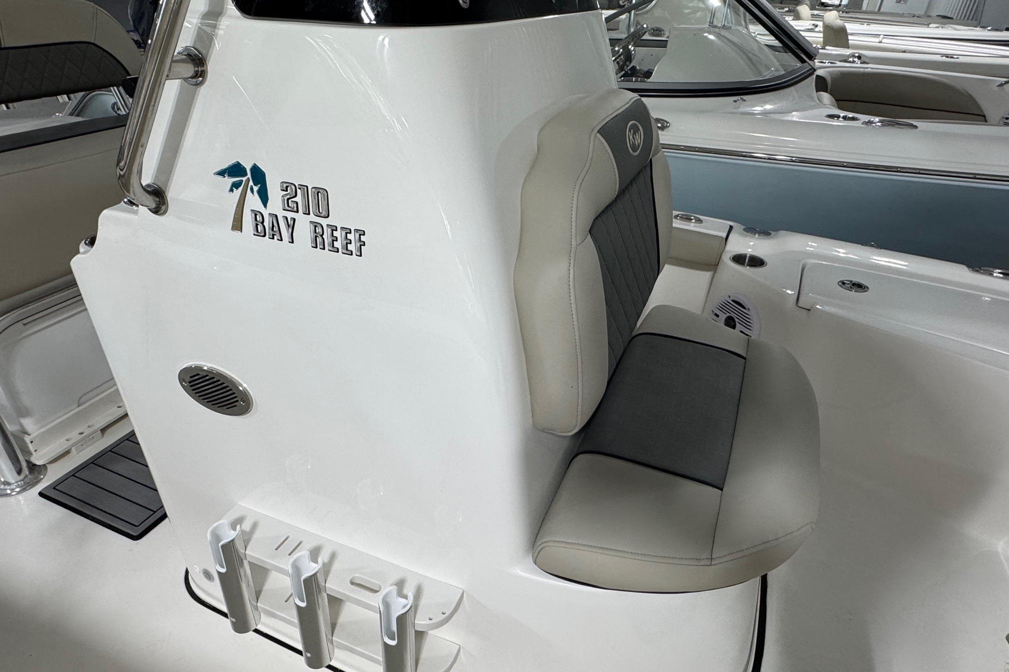 2026 Key West 210 Bay Reef boat interior with cushioned seating and rod holders.