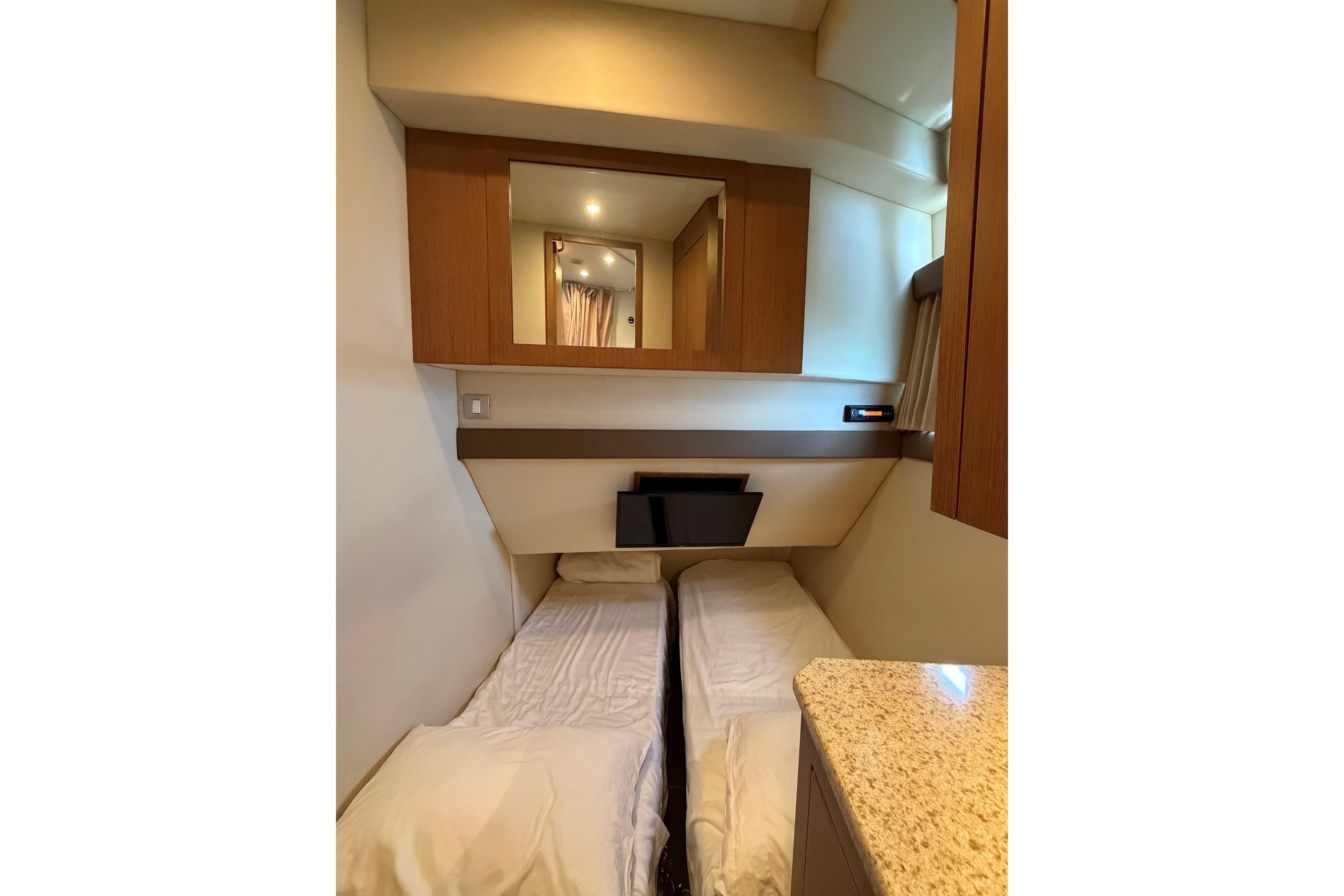 Interior cabin of 2011 Carver 44 Sojourn yacht with bed and mirror.