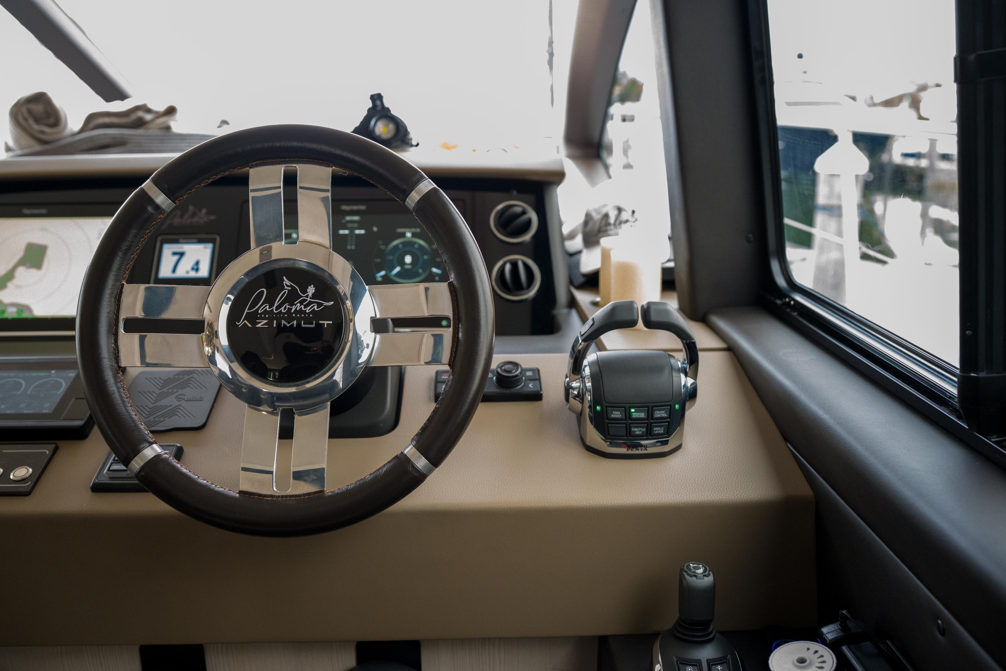 Steering wheel and controls of 2019 Azimut Fly 50 yacht cockpit.