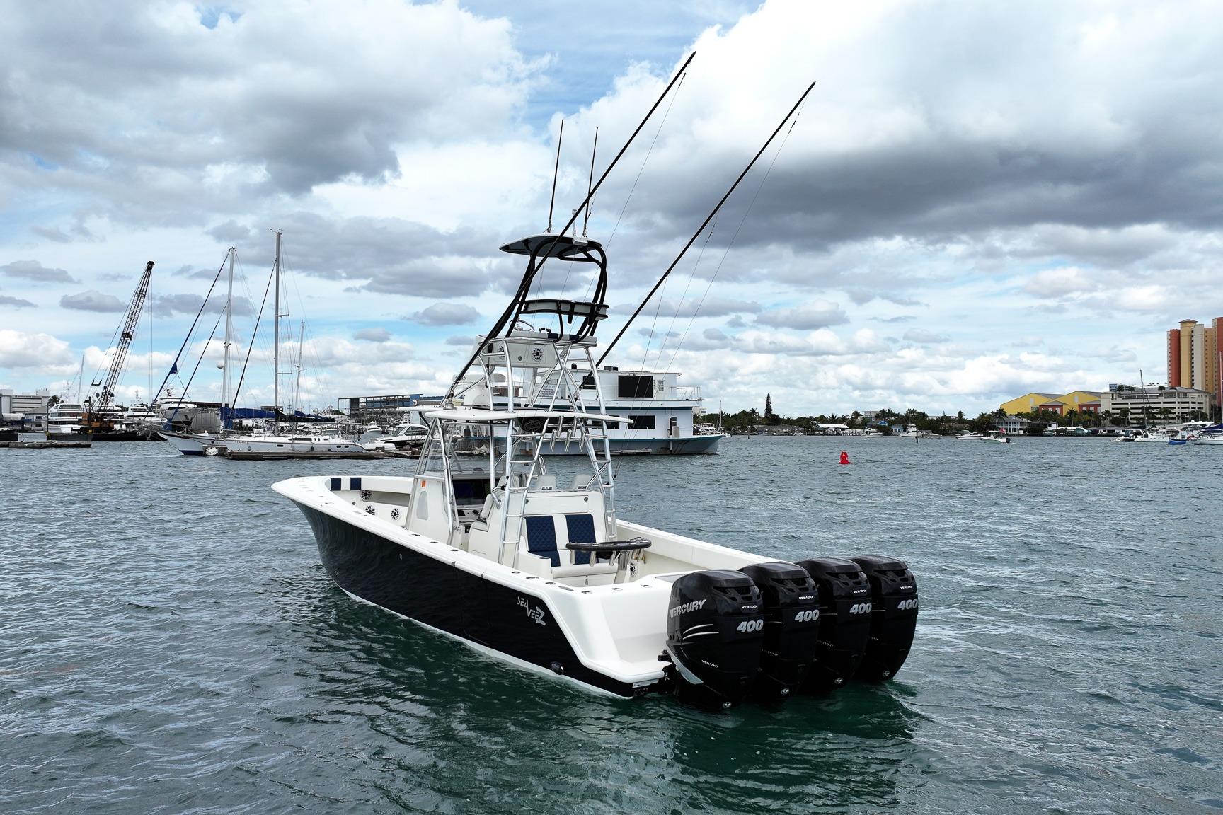 2022 SeaVee 390Z boat with four outboard engines on a calm harbor.