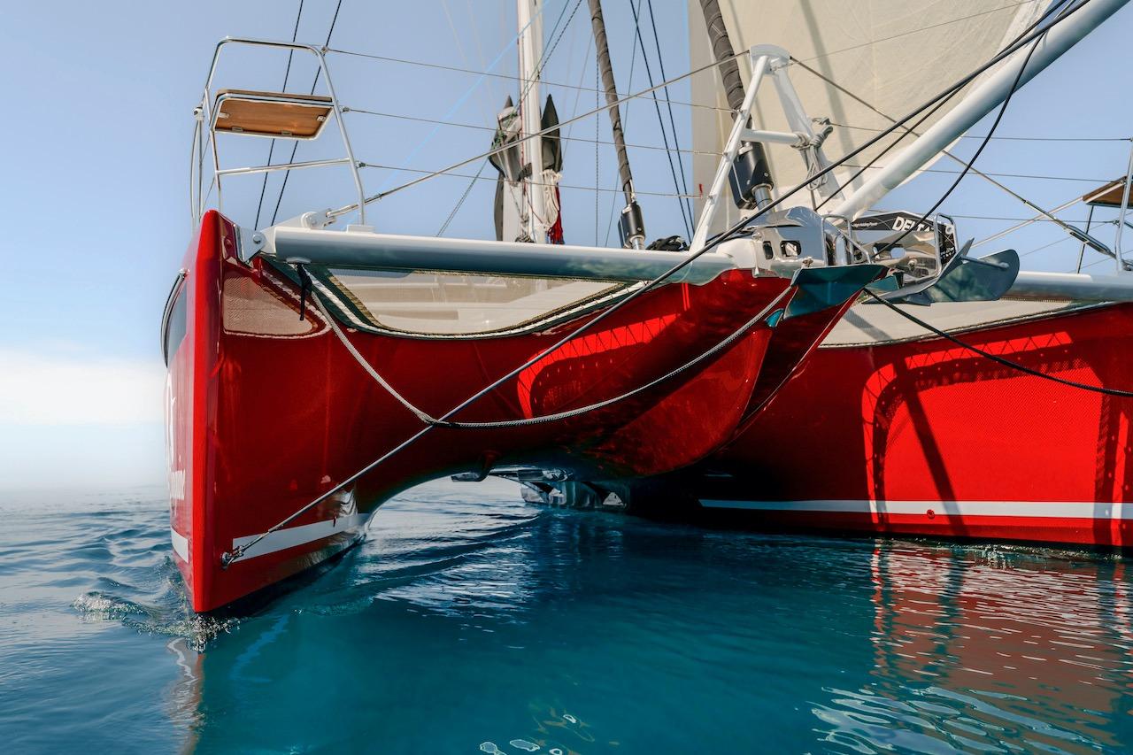 Red Privilege Signature 510 catamaran on calm water, year 2025.