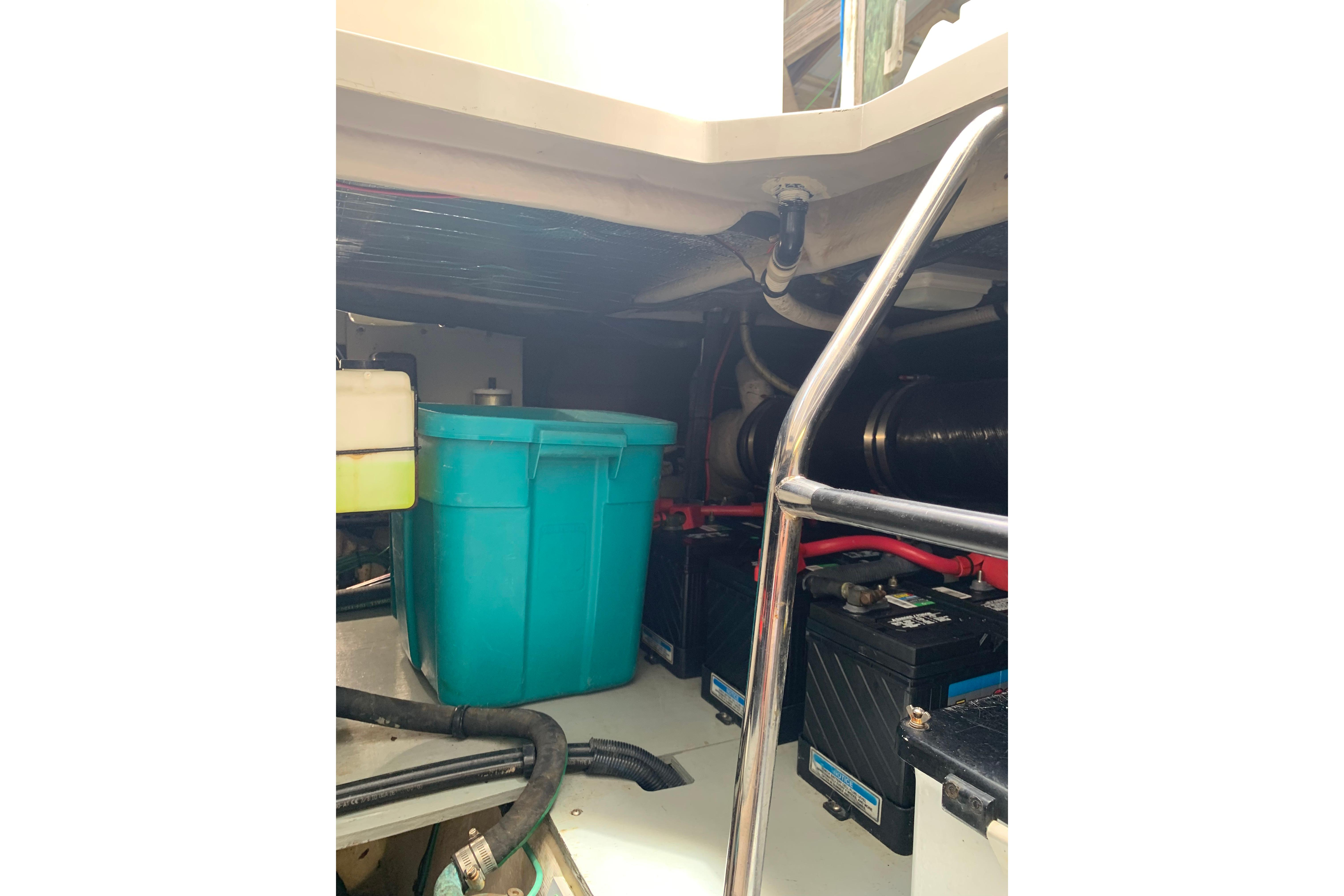 Engine room of 2004 Sea Ray 420 Sedan Bridge with storage bin and batteries.