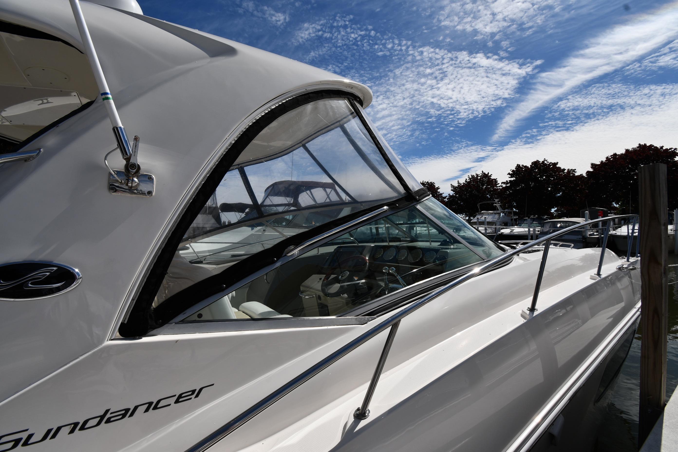 2008 Sea Ray Sundancer 350 yacht docked under a clear blue sky.