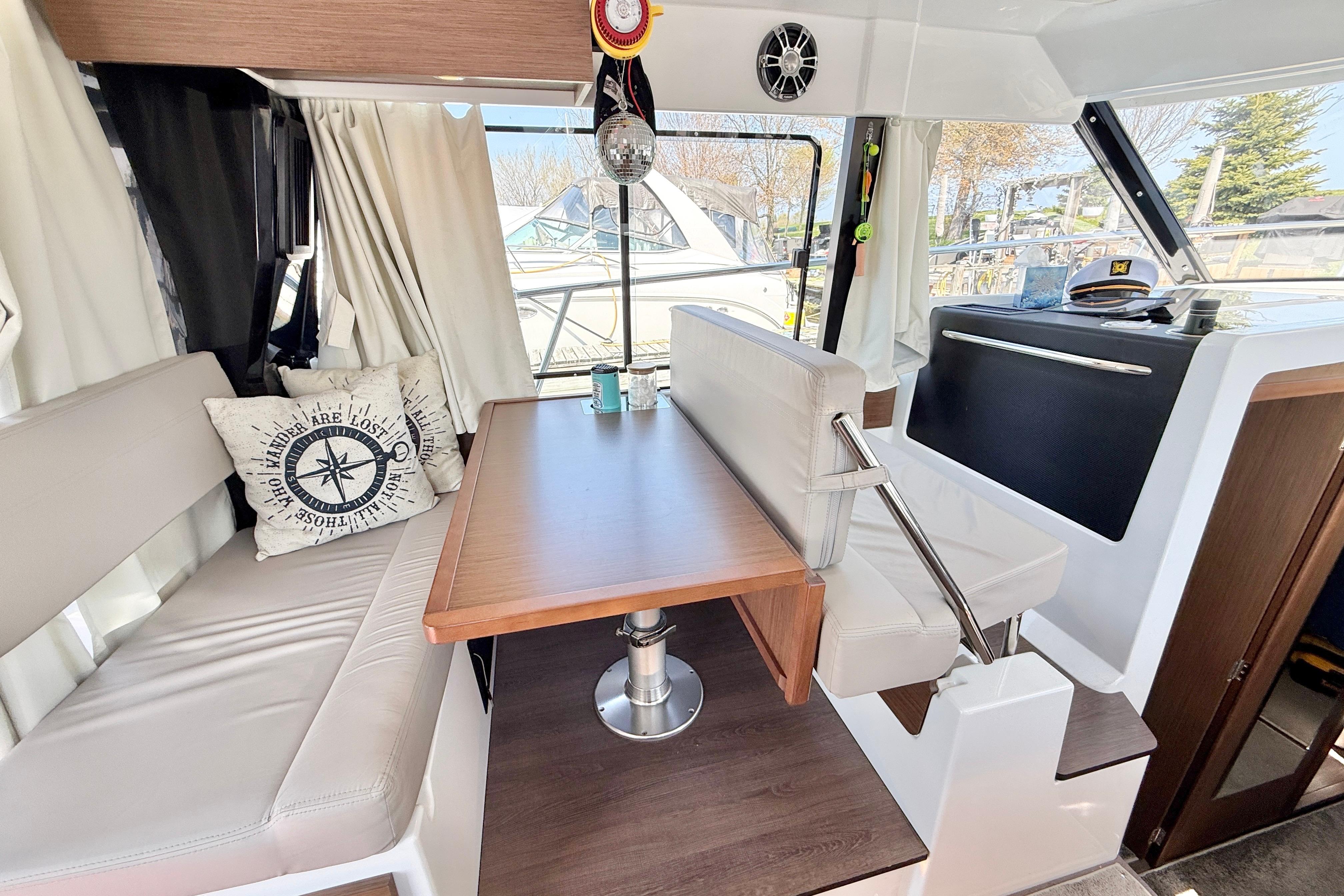 Interior of 2022 Jeanneau NC 1095 Fly boat with cozy seating and nautical decor.