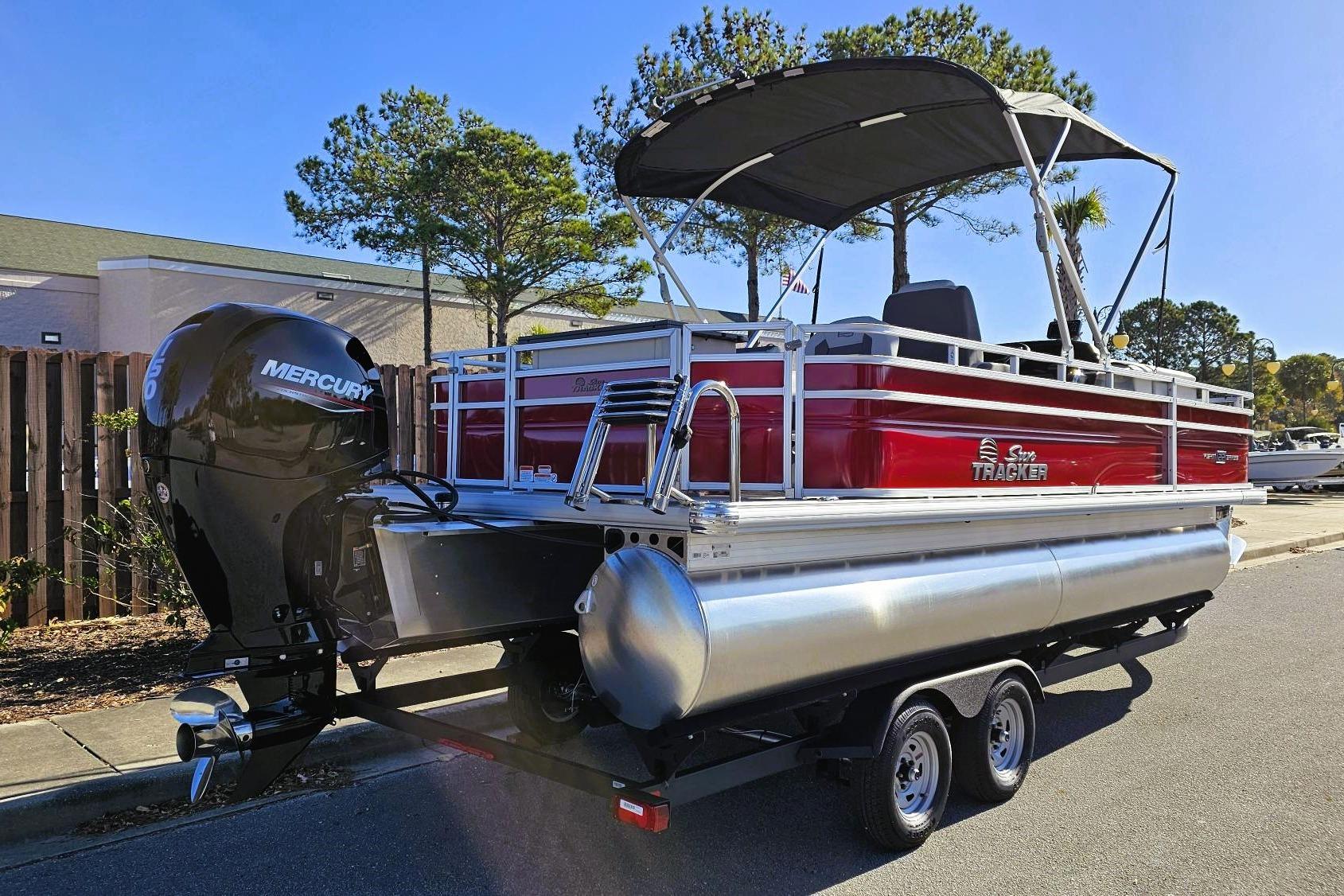 2026 Sun Tracker Fishin' Barge 22 DLX pontoon boat with Mercury outboard motor.