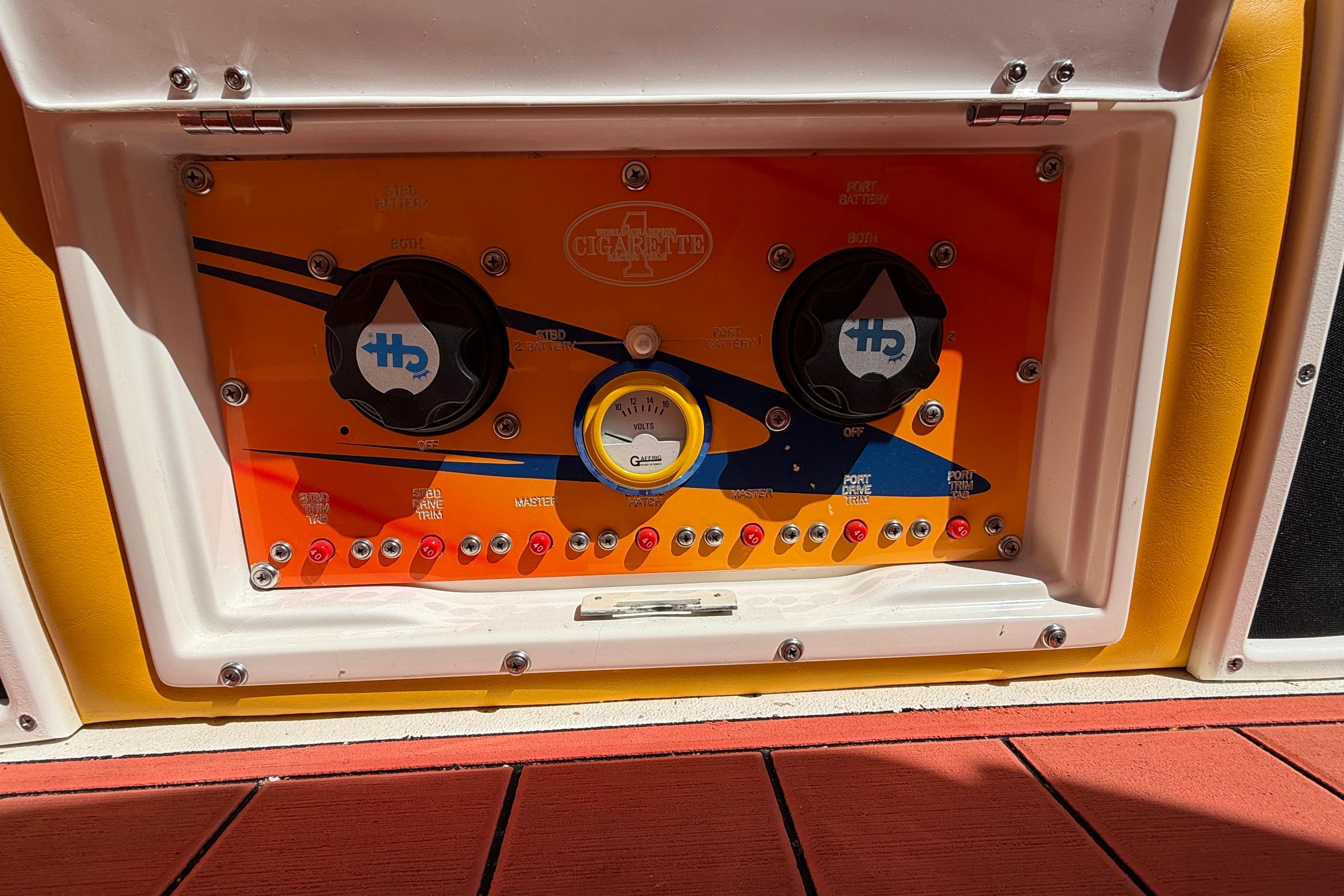 Control panel of a 2002 Cigarette 35' Cafe Racer boat with vibrant design.