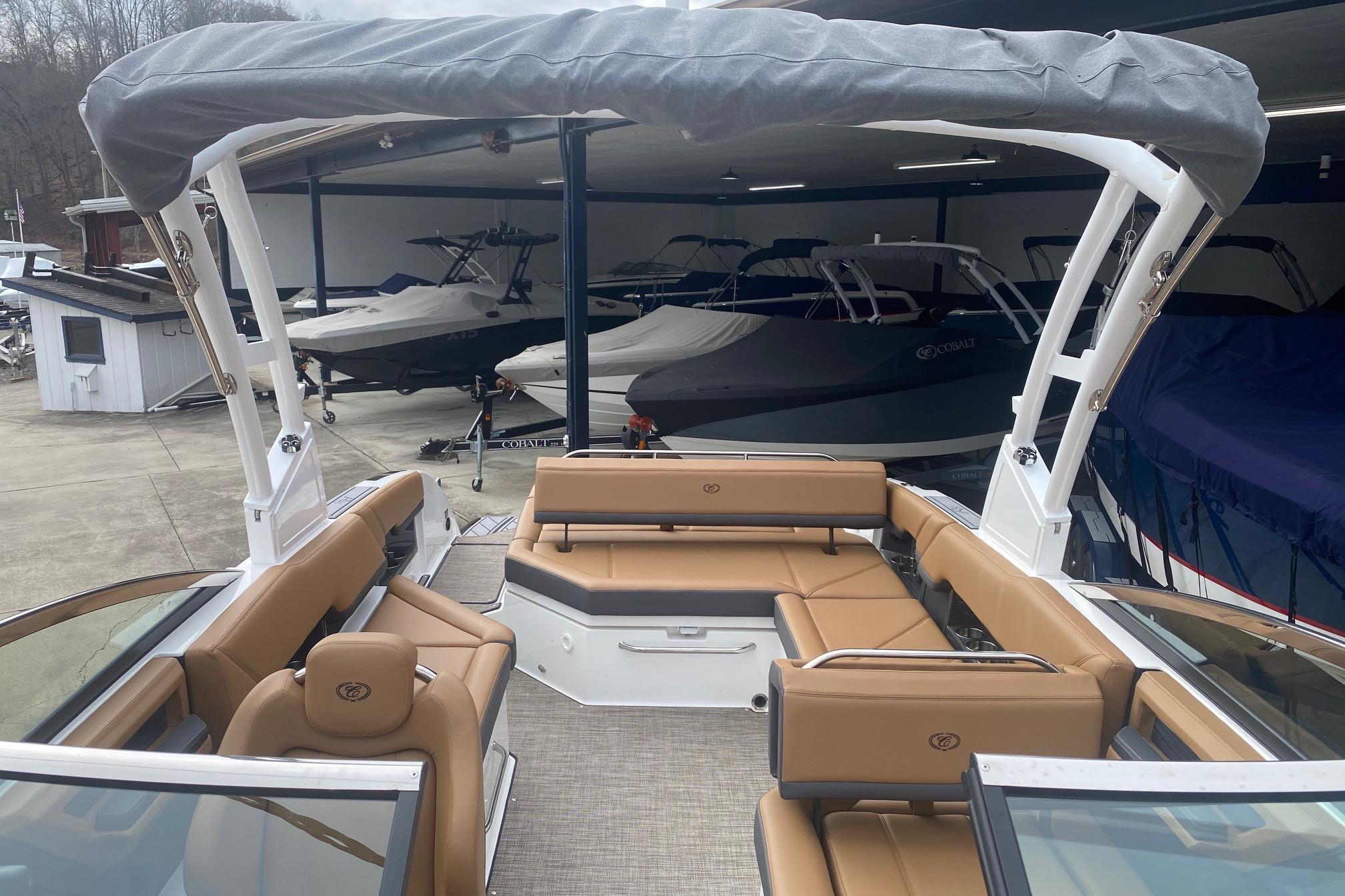 2022 Cobalt R8 boat with tan seating and covered deck in showroom.
