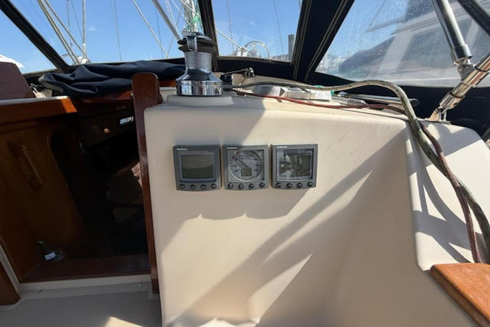 Cockpit instruments on a 2001 Island Packet 380 sailboat under clear skies.