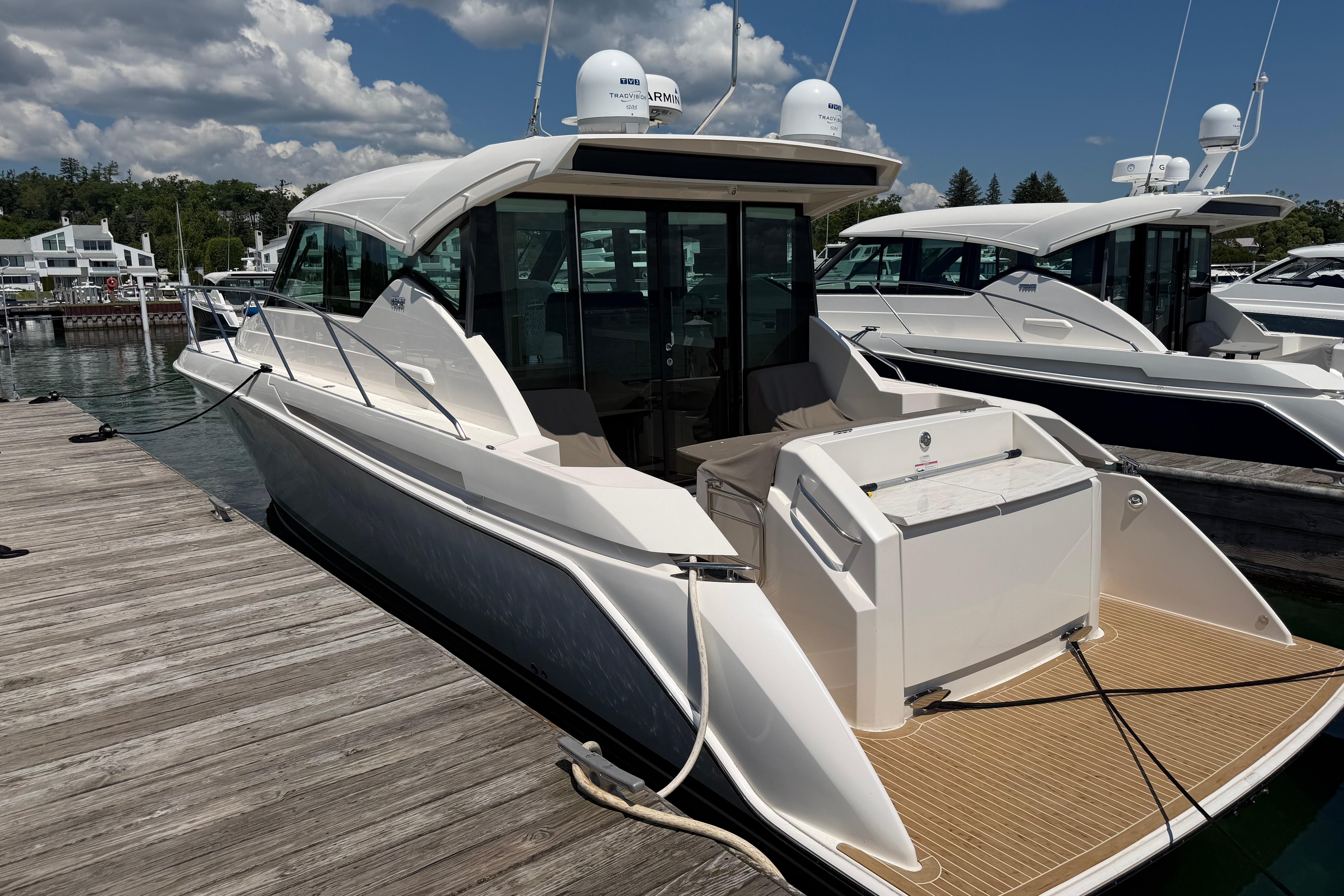 2016 Tiara Yachts C39 Coupe docked at marina under cloudy sky.