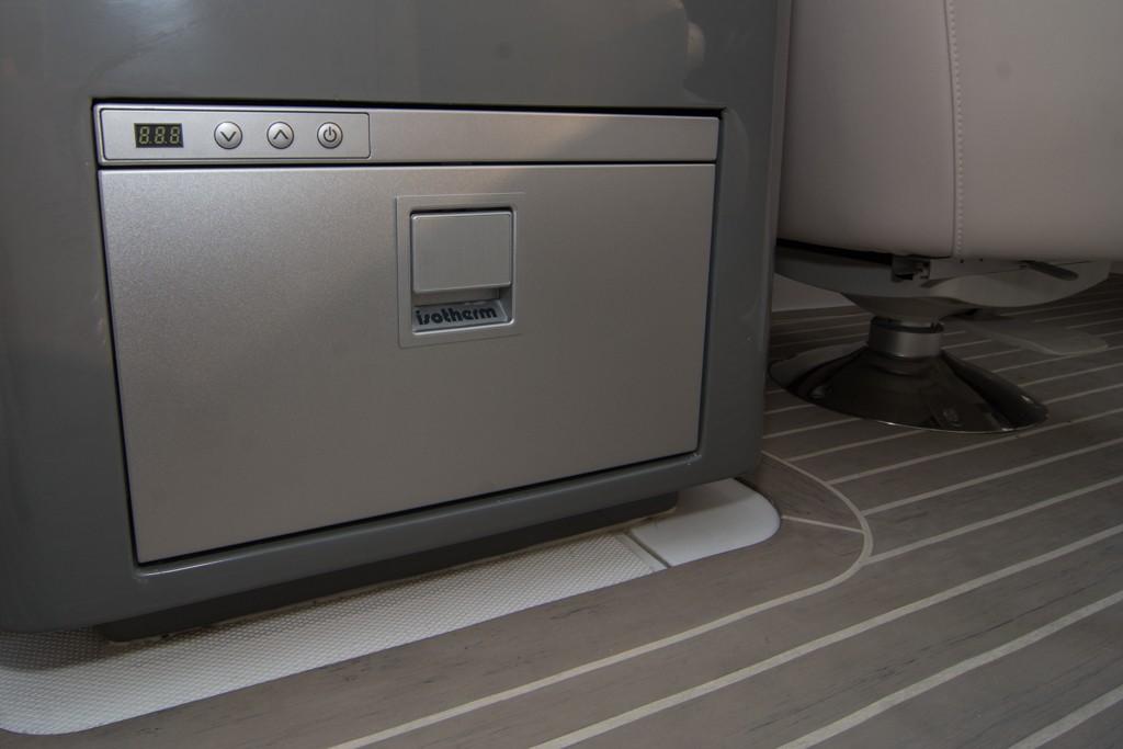 2019 Donzi 41 GT interior, featuring a built-in Isotherm refrigerator and modern flooring.