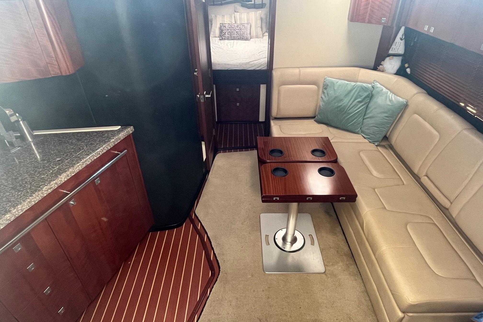 Luxurious interior of 2010 Monterey 400 Sport Yacht with leather seating and modern kitchen.
