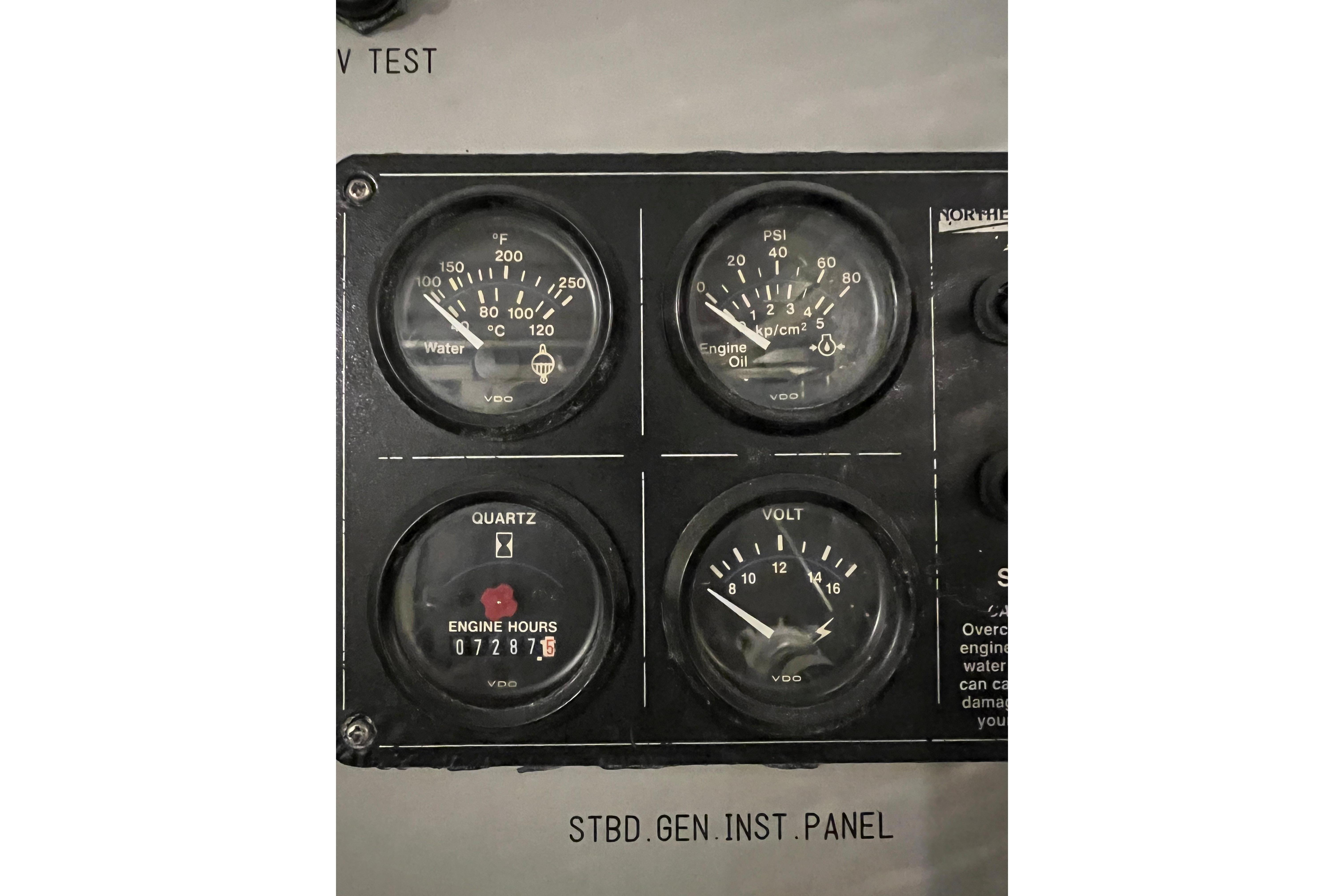 Monte Fino 92 yacht instrument panel with gauges for water temperature, engine oil, hours, and voltage.