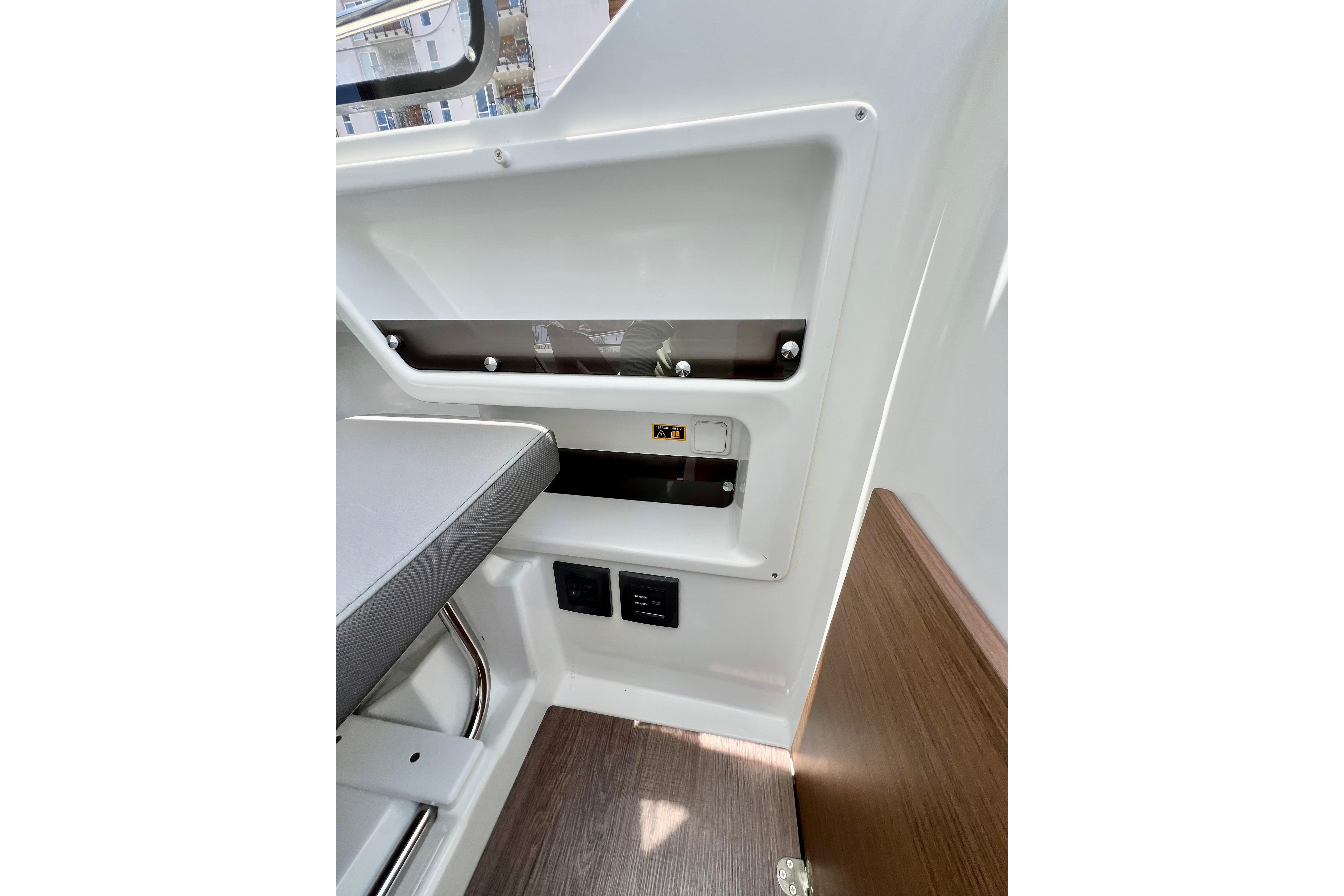 Interior view of 2023 Beneteau Antares 8, showcasing seating and control panel details.