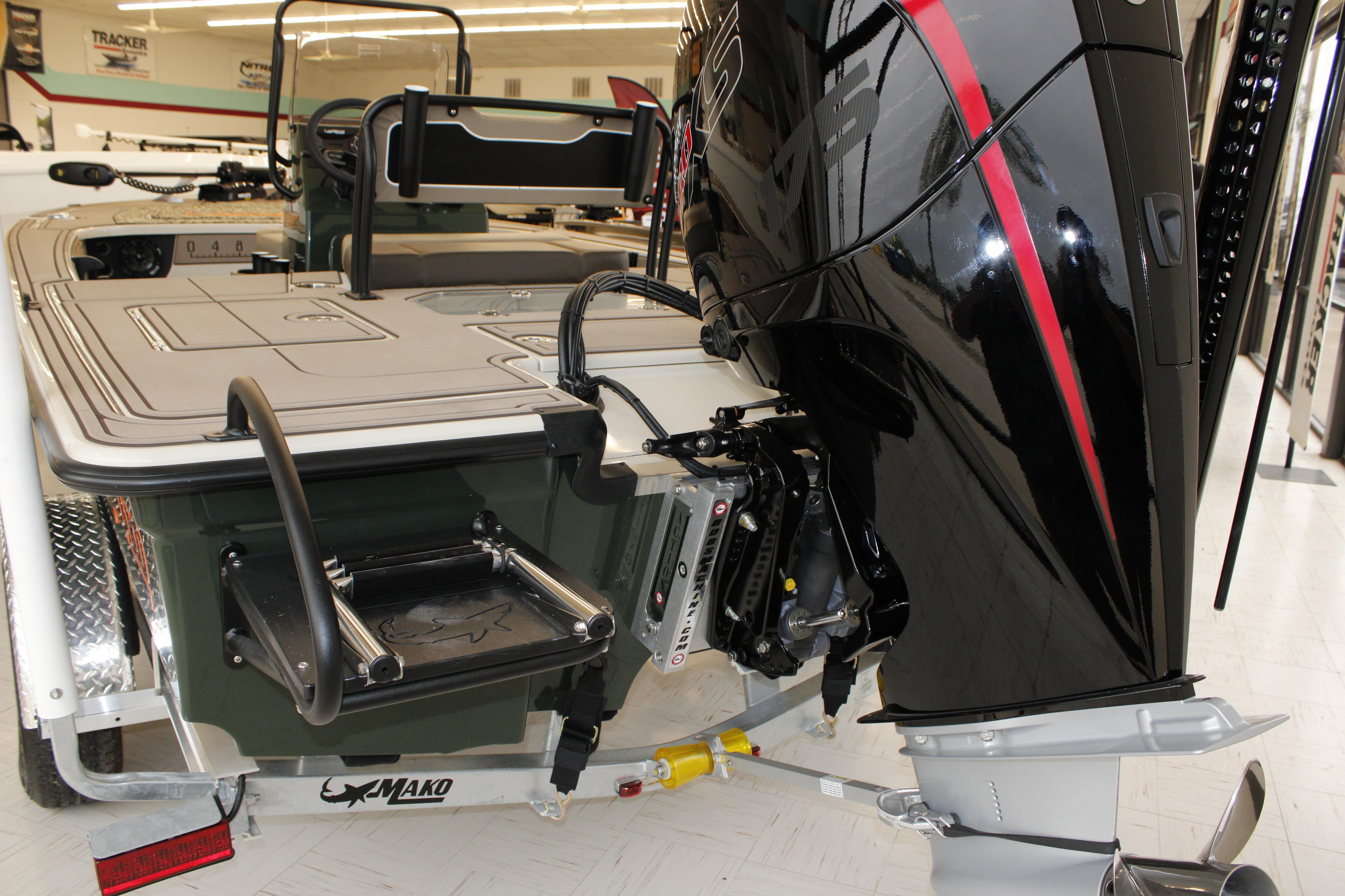 2026 Mako 18 Pro Skiff Backwater Edition with powerful outboard motor in showroom.