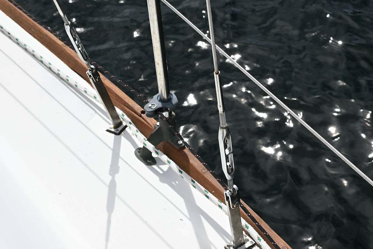 Close-up of 1977 Mercator Offshore sailboat rigging over shimmering water.