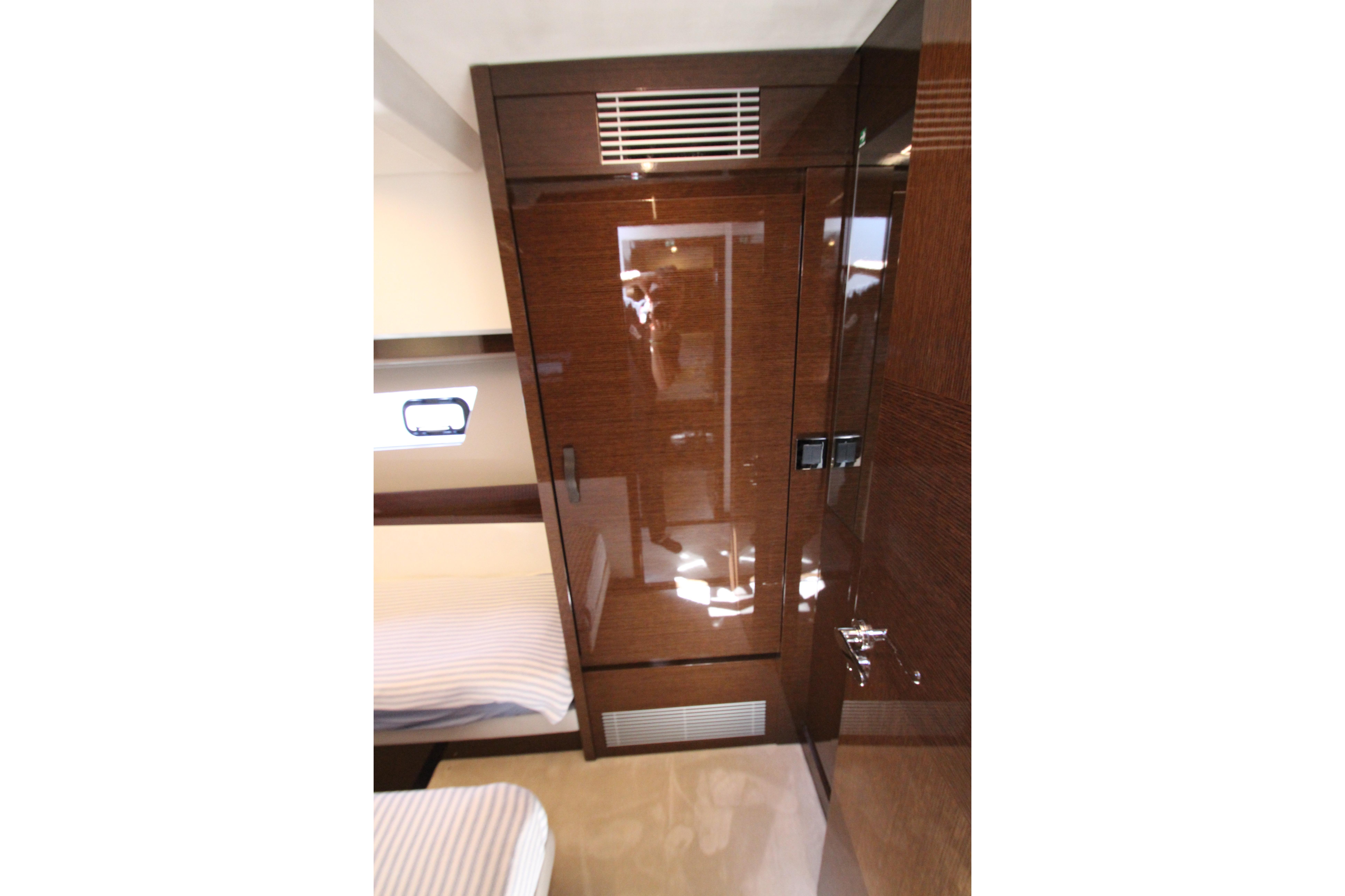 Interior of 2022 Prestige 520 yacht with glossy wood finish and modern design.