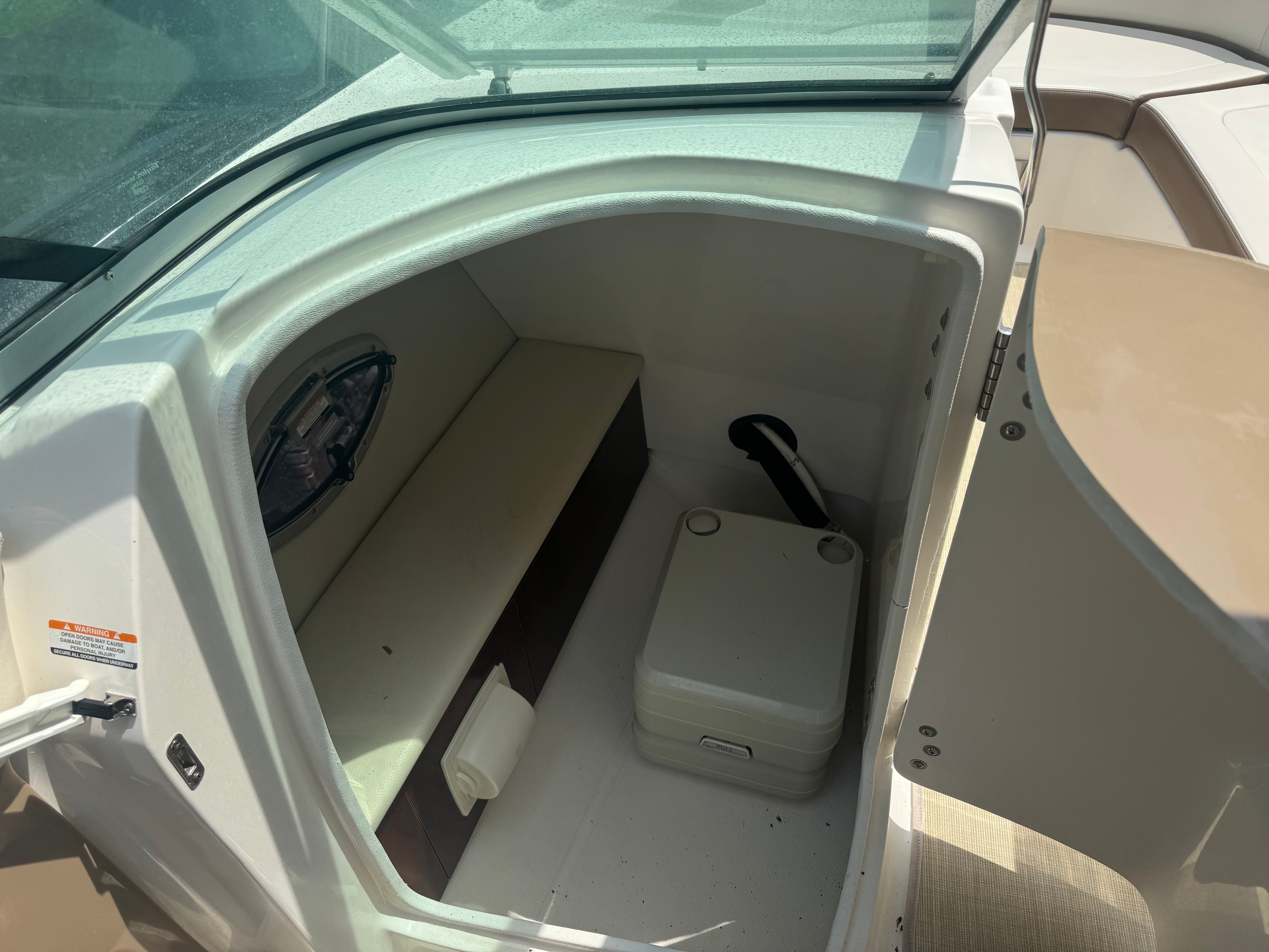 Interior of a 2016 Chaparral 246 SSi boat with storage area.