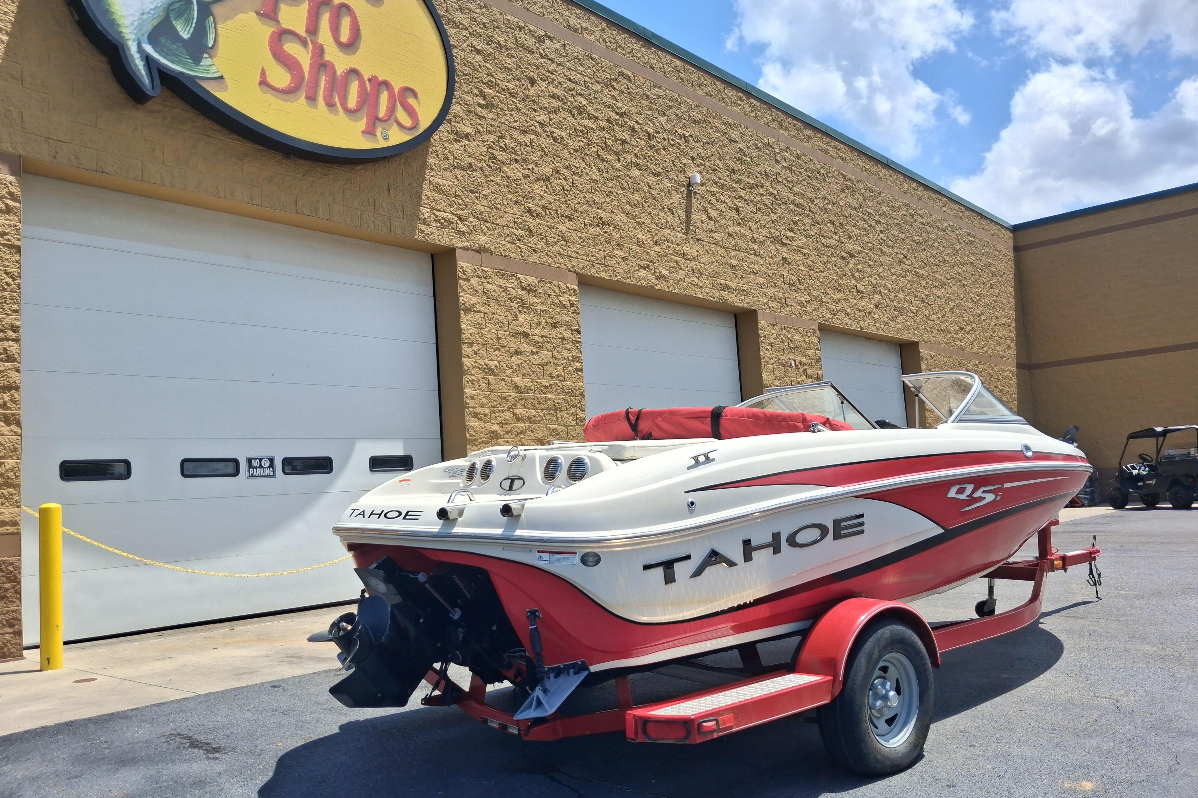 2014 Tahoe Q5i boat on trailer outside Pro Shops building.