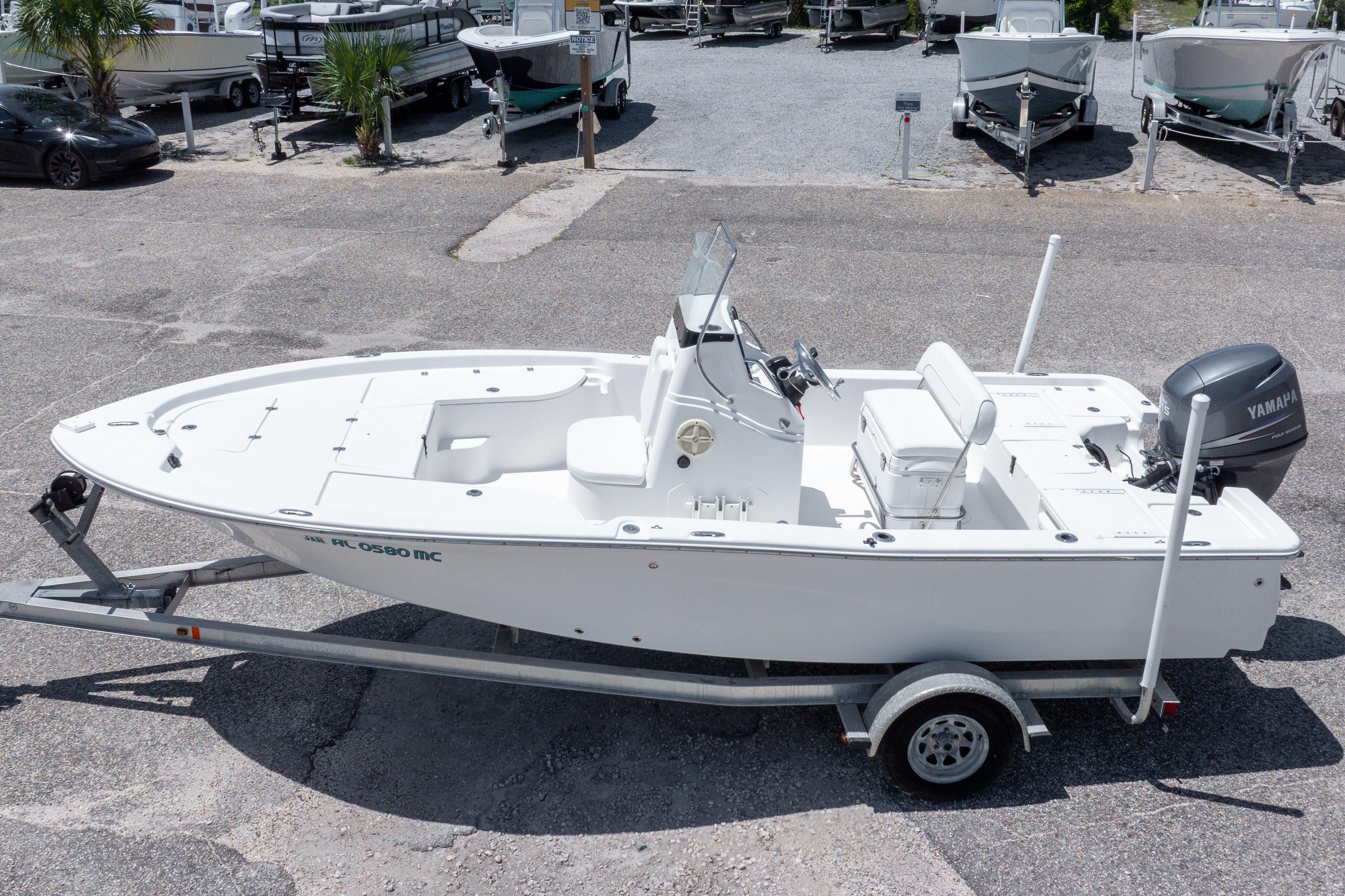 2011 Sea Fox 200XT boat on trailer, parked in a marina with other boats.