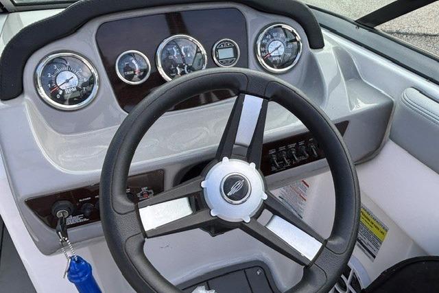 Dashboard of 2021 Chaparral 21 SSi boat with steering wheel and gauges.