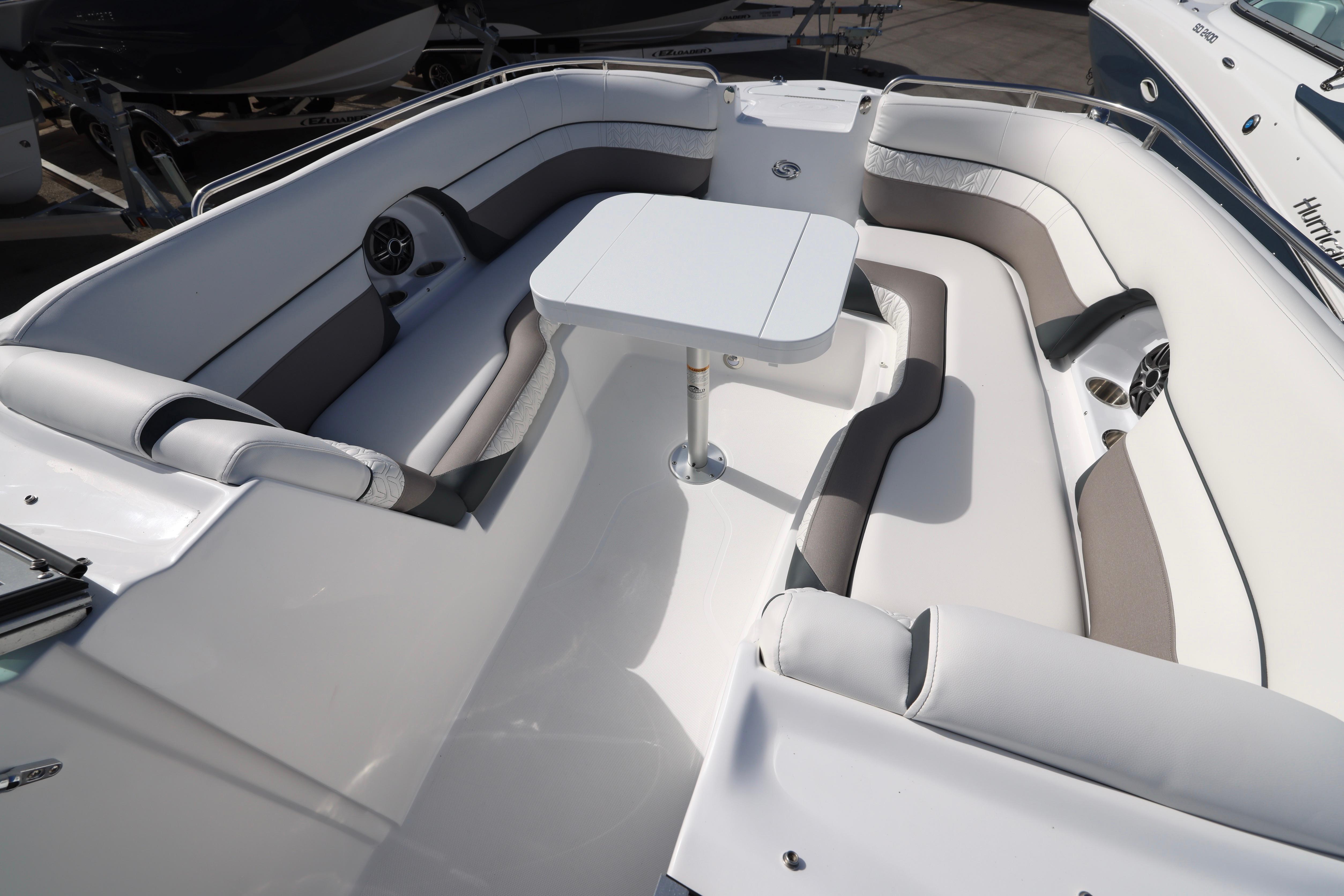 2026 Hurricane SunDeck 2486 OB boat interior with spacious seating and table.