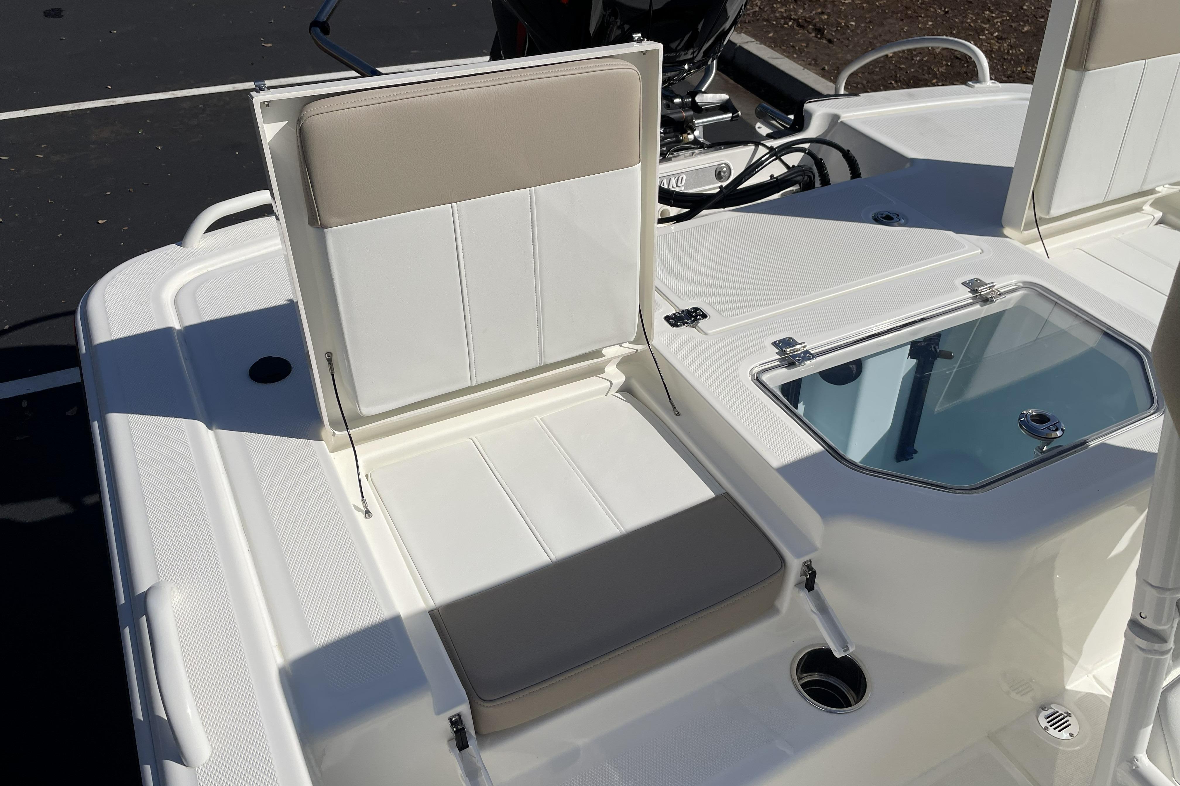 2026 Mako Pro Skiff 19 CC boat interior with seating and storage compartments.