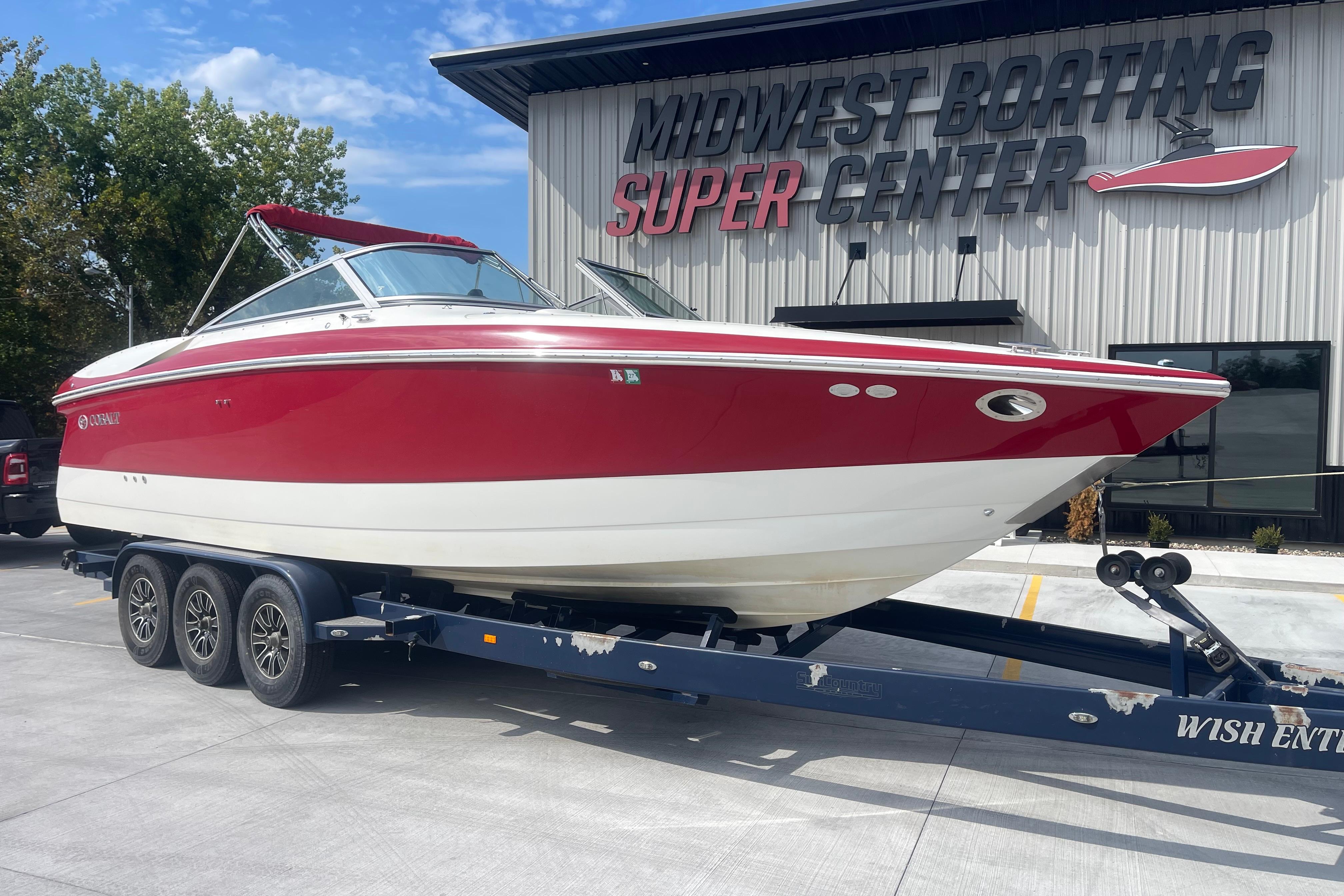 Red and white 2004 Cobalt 282 boat on trailer at Midwest Boating Super Center.