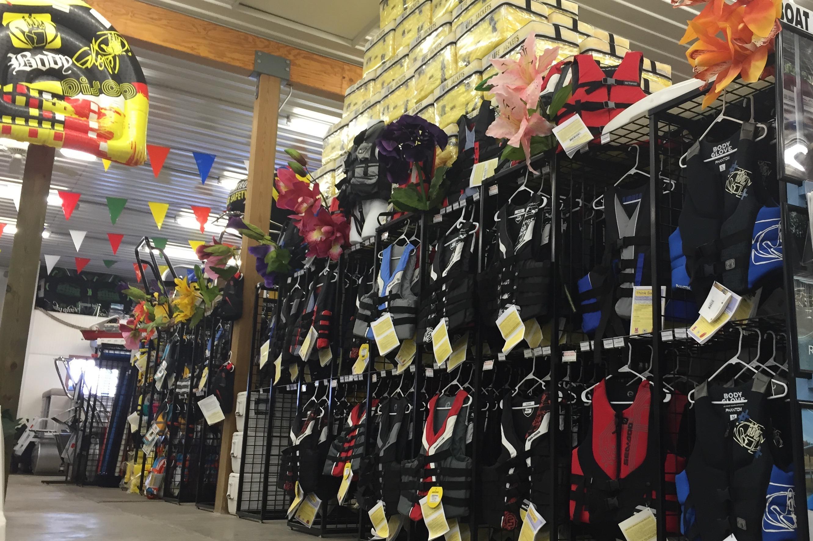 Colorful life jackets displayed in a store, featuring Barletta Aria 20L 2026 model.