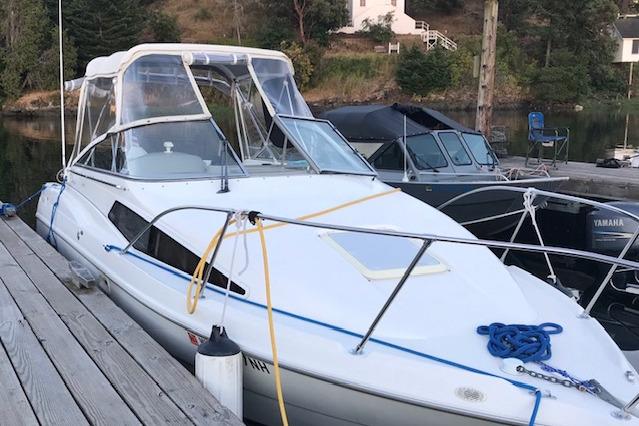 1998 Bayliner 2655 Ciera Sunbridge docked at a marina, featuring a sleek white design.