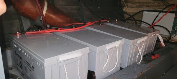 1951 Chris-Craft Catalina boat batteries with red cables in engine compartment.
