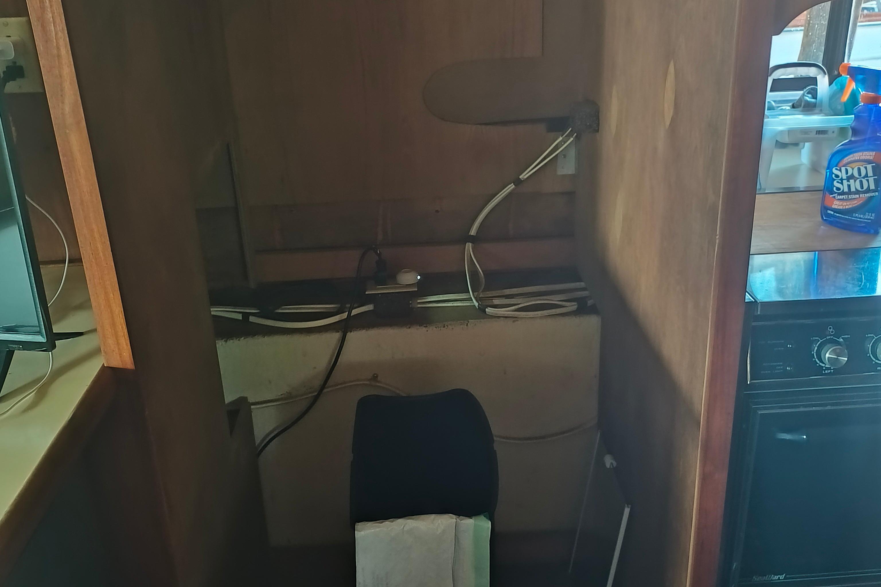 Interior of a 1988 Blue Water Coastal Cruiser with cleaning supplies and appliances.