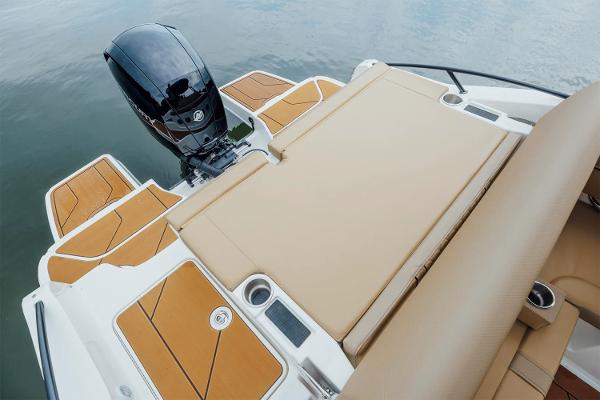 Manufacturer Provided Image: 2025 Bayliner D20 boat with tan seating and outboard motor on calm water.
