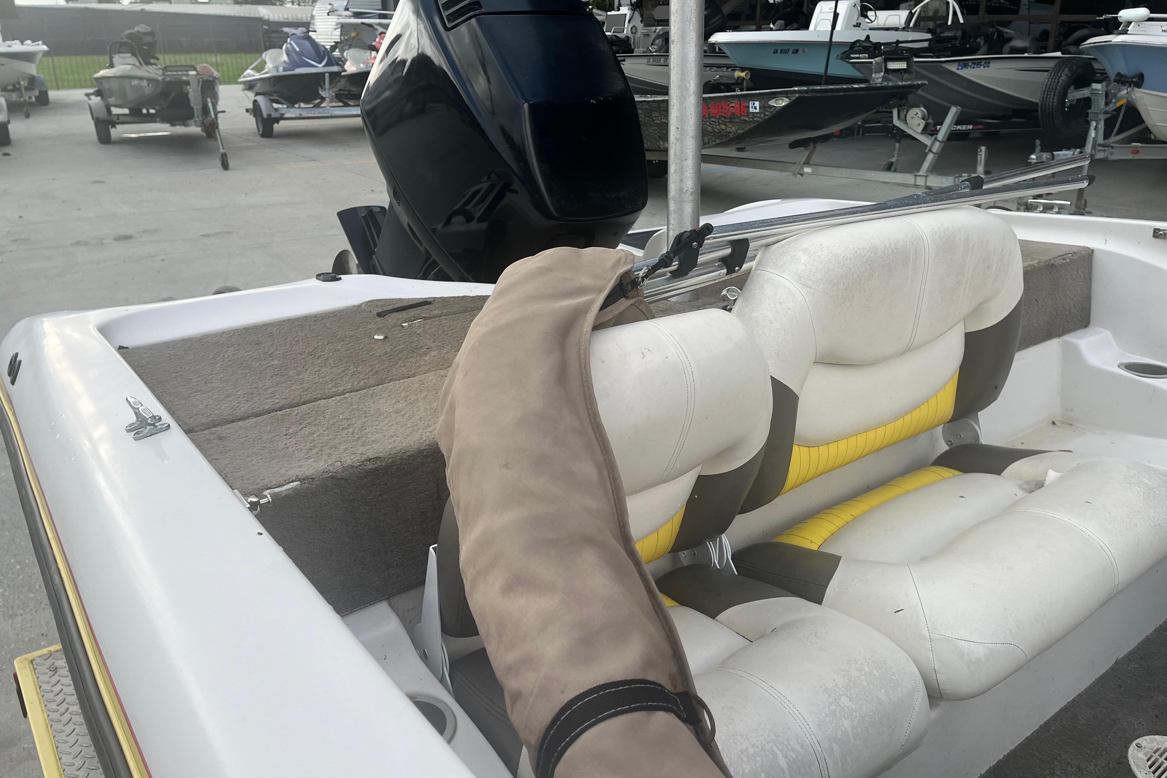 2006 Nitro 189 Sport boat interior with white and yellow seating, docked at marina.