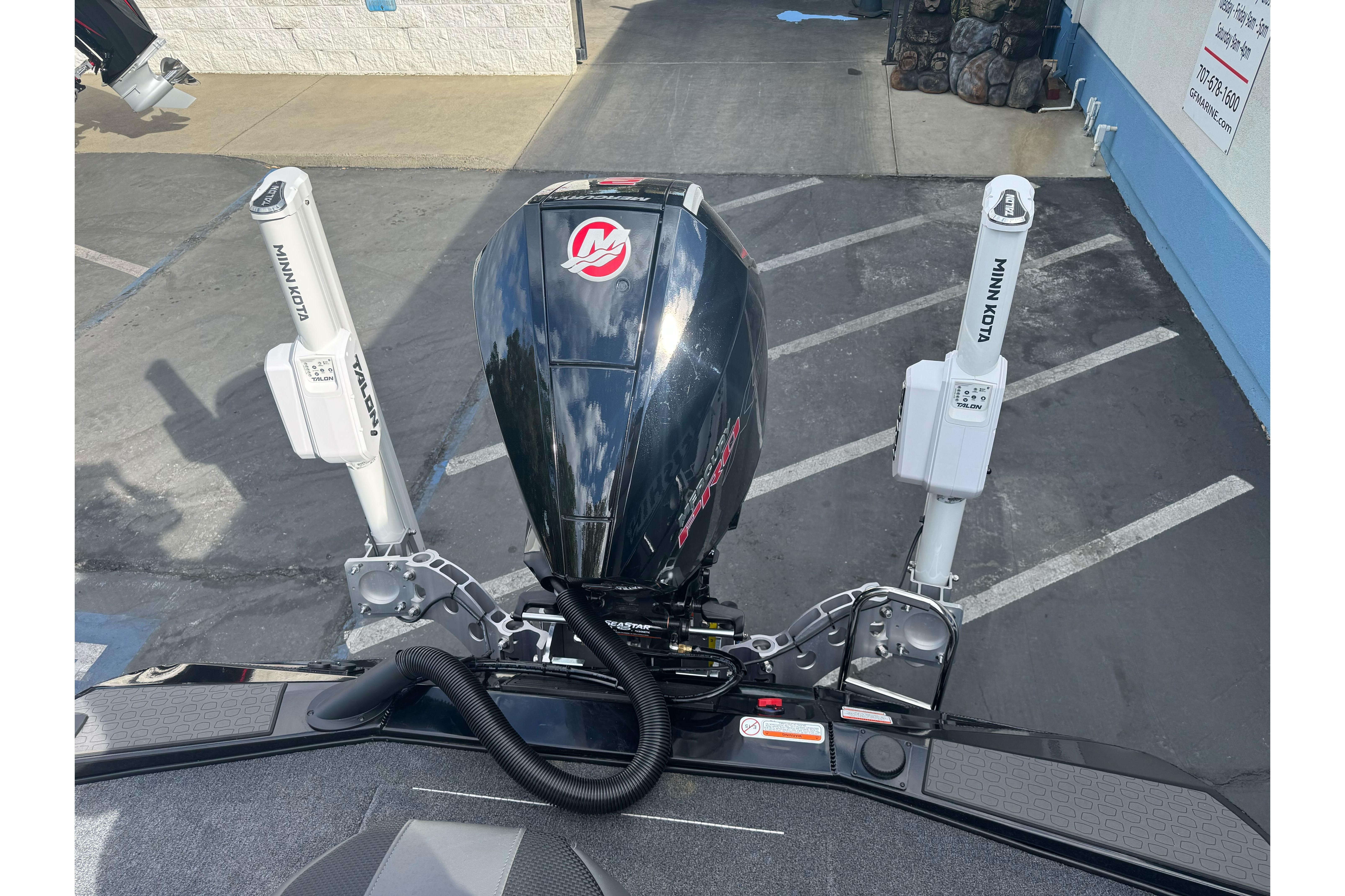 2026 Ranger ALPHA 208 boat engine with Minn Kota Talon anchors in a parking lot.