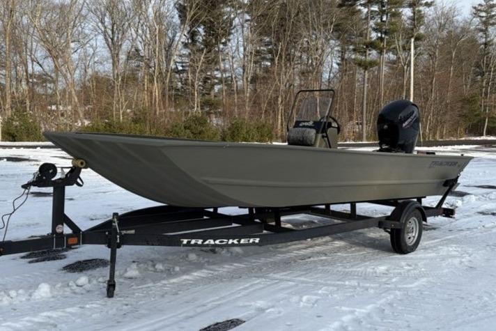 2026 Tracker Grizzly 2072 CC boat on trailer in snowy landscape.