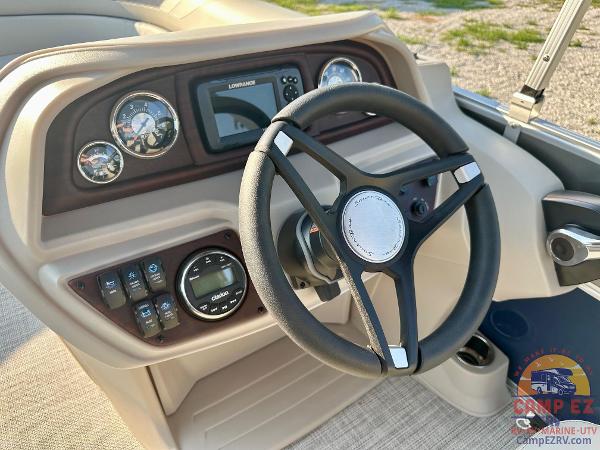 2025 South Bay 224FCR LE boat dashboard with steering wheel and control panel.