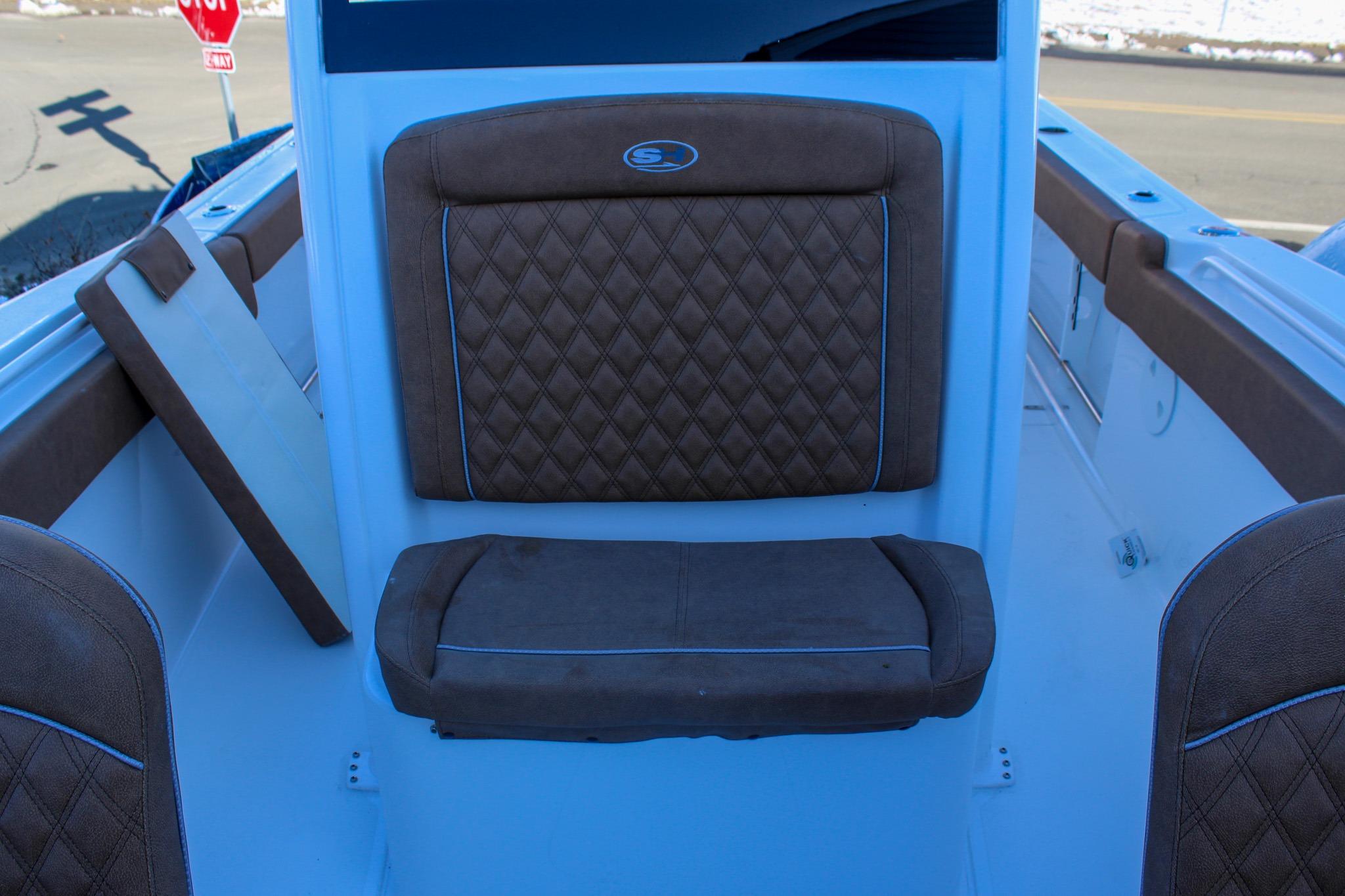 2026 Sea Hunt Gamefish 25 boat interior with brown diamond-stitched seating.