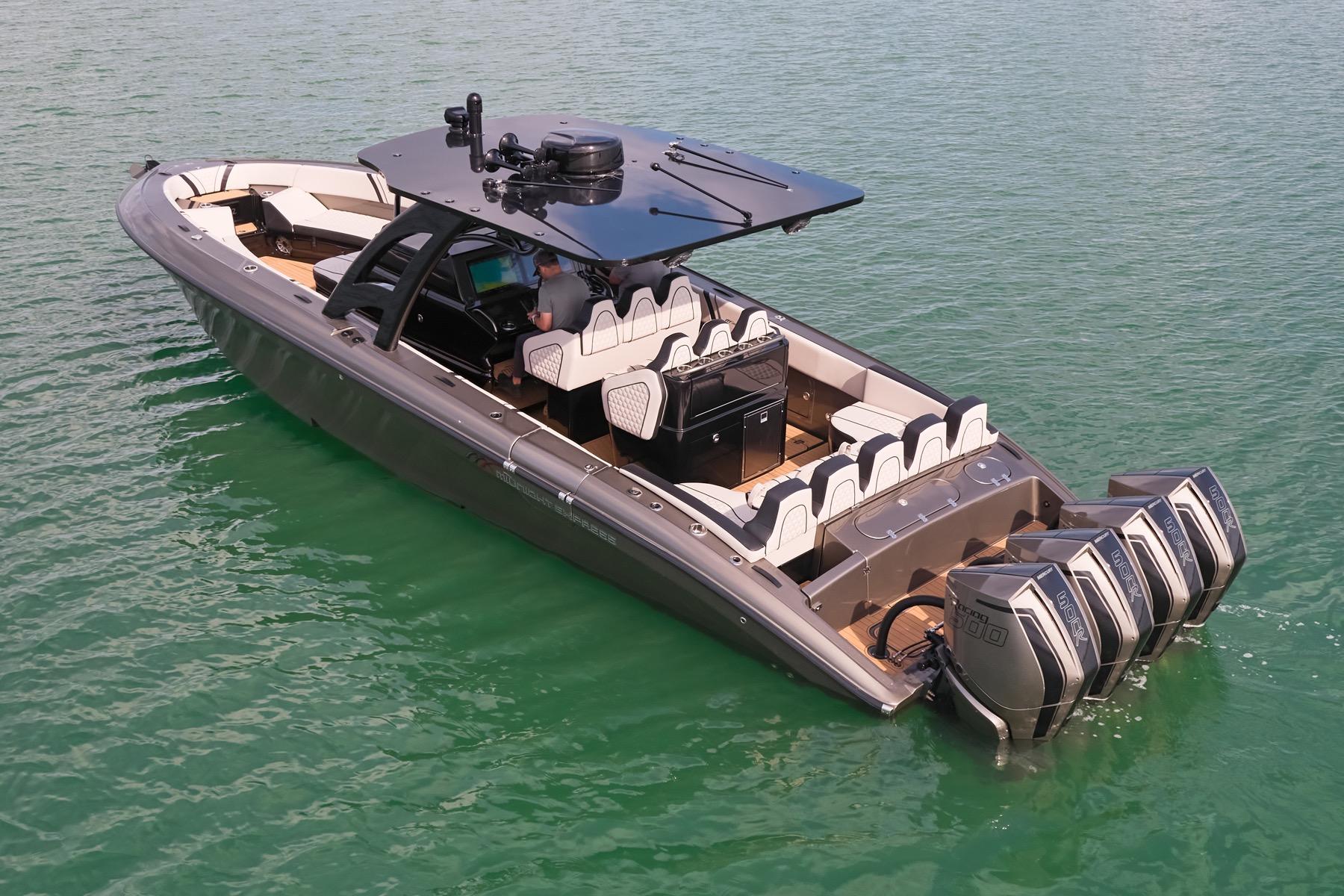 2025 Midnight Express 37 Open boat with quad engines on calm water.