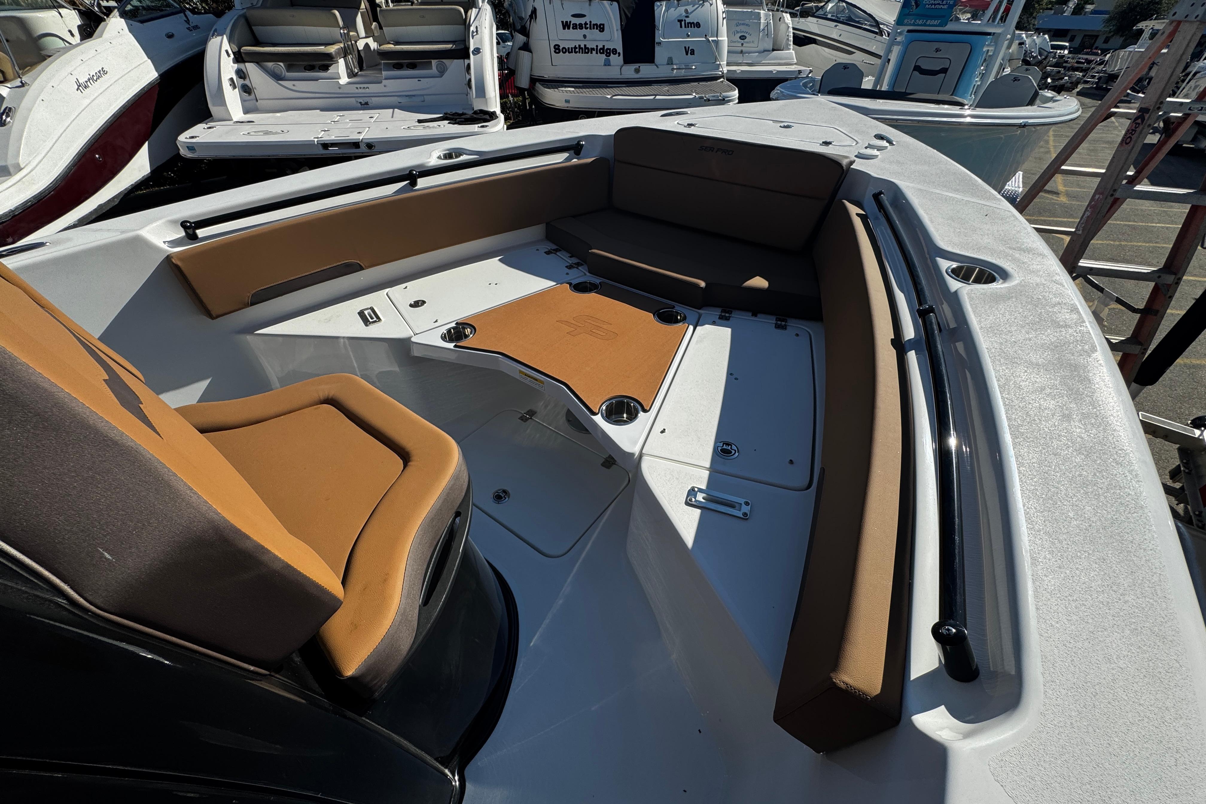 2026 Sea Pro 245FLX Sandbar boat interior with tan seating and storage compartments.