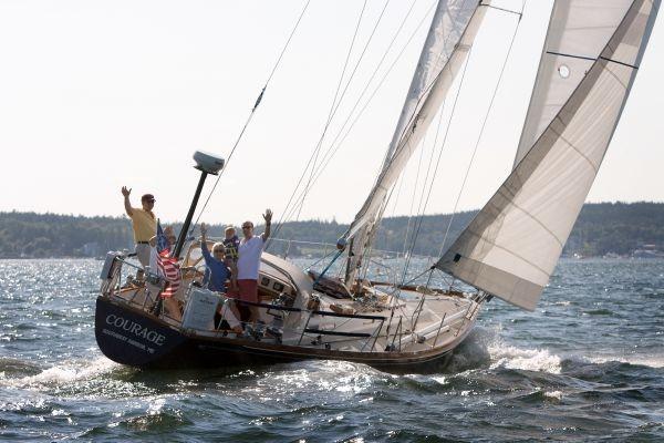 Sailing on a 1980 Hinckley 43 yacht named "Courage" with people waving.