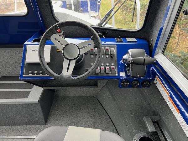 2024 Spartan 26 Maximus Pro XL boat cockpit with steering wheel and control panel.
