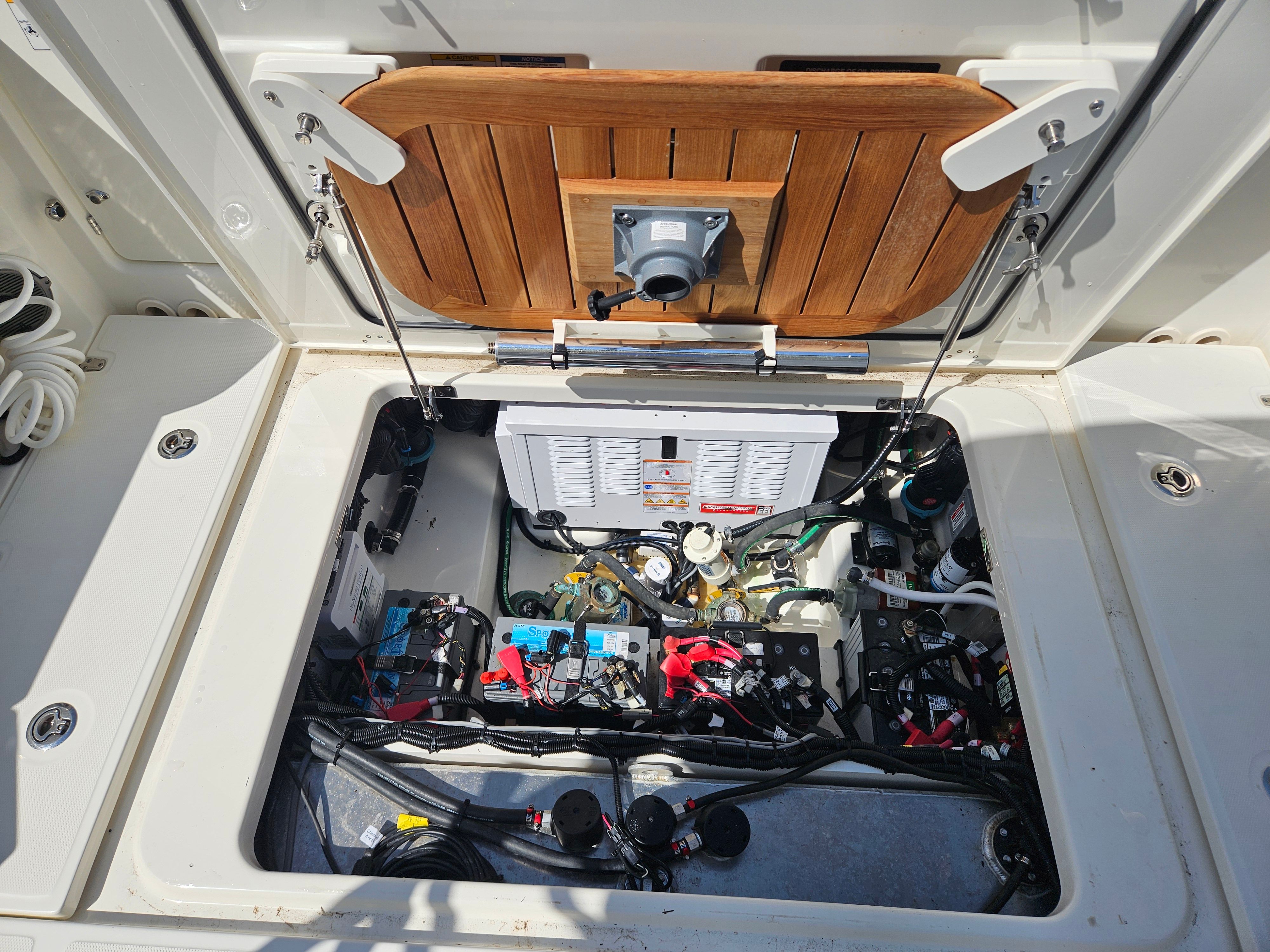 An open engine compartment with various cables and equipment.