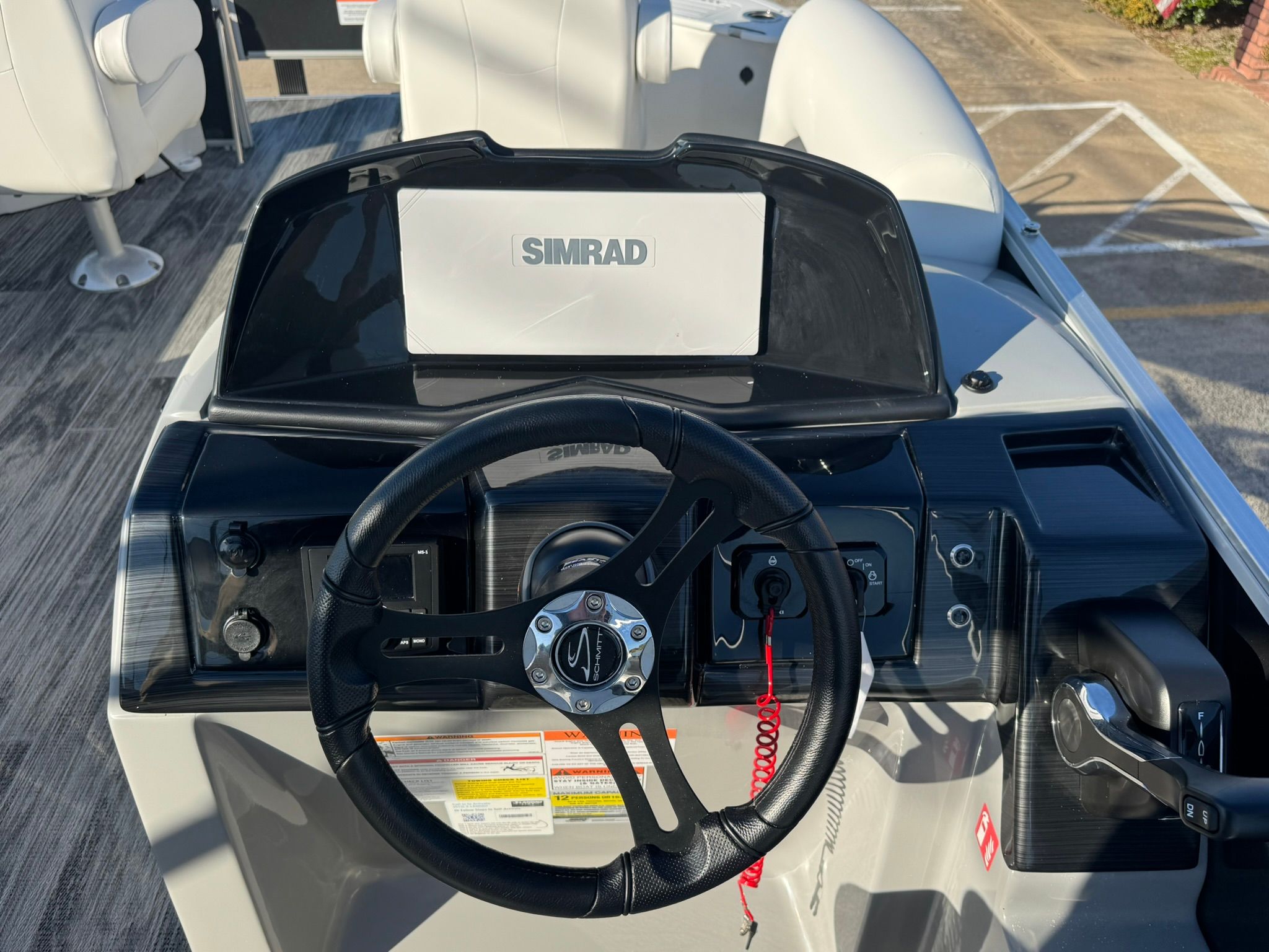 Steering console of Landau 23C Atlantis 2026 with Simrad display.