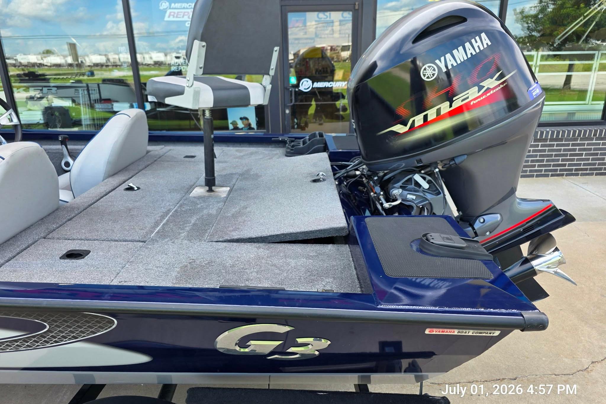 2017 G3 Sportsman 18 boat with Yamaha VMAX engine, parked outside a showroom.