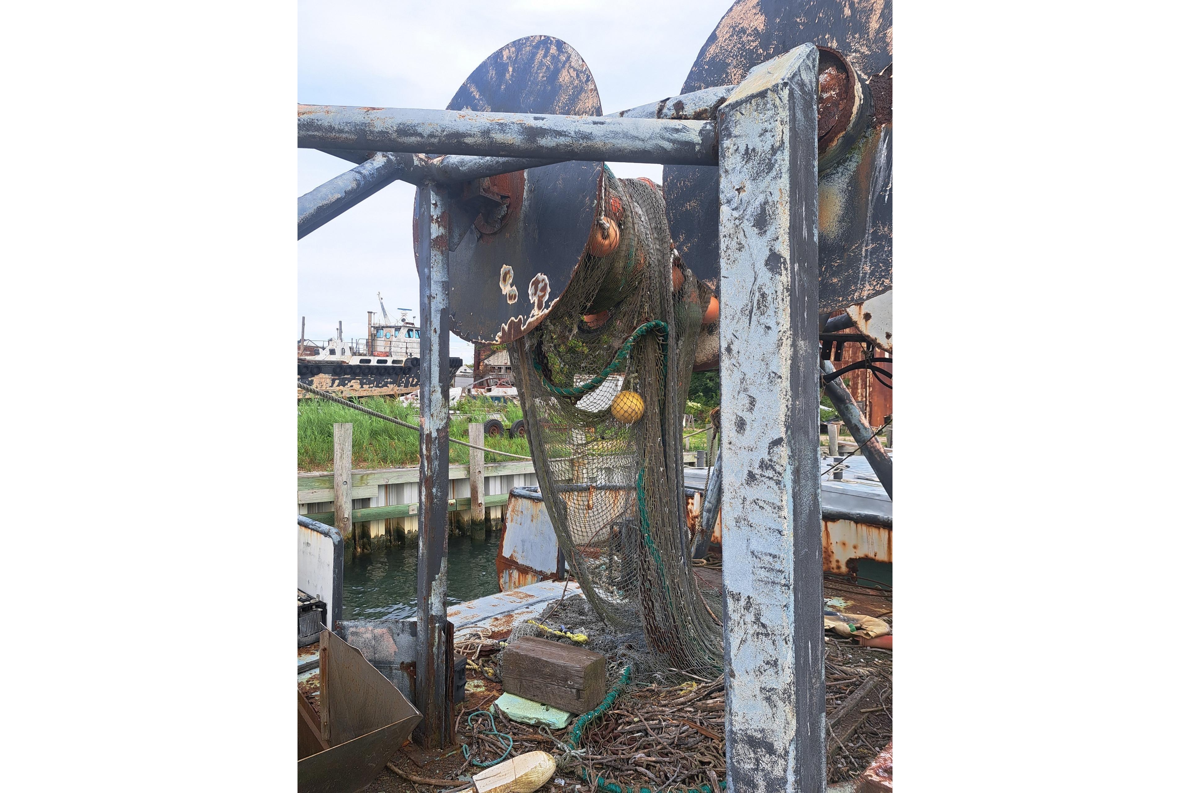 Rusty 1979 Custom Steel Trawler Dragger with fishing net and equipment.
