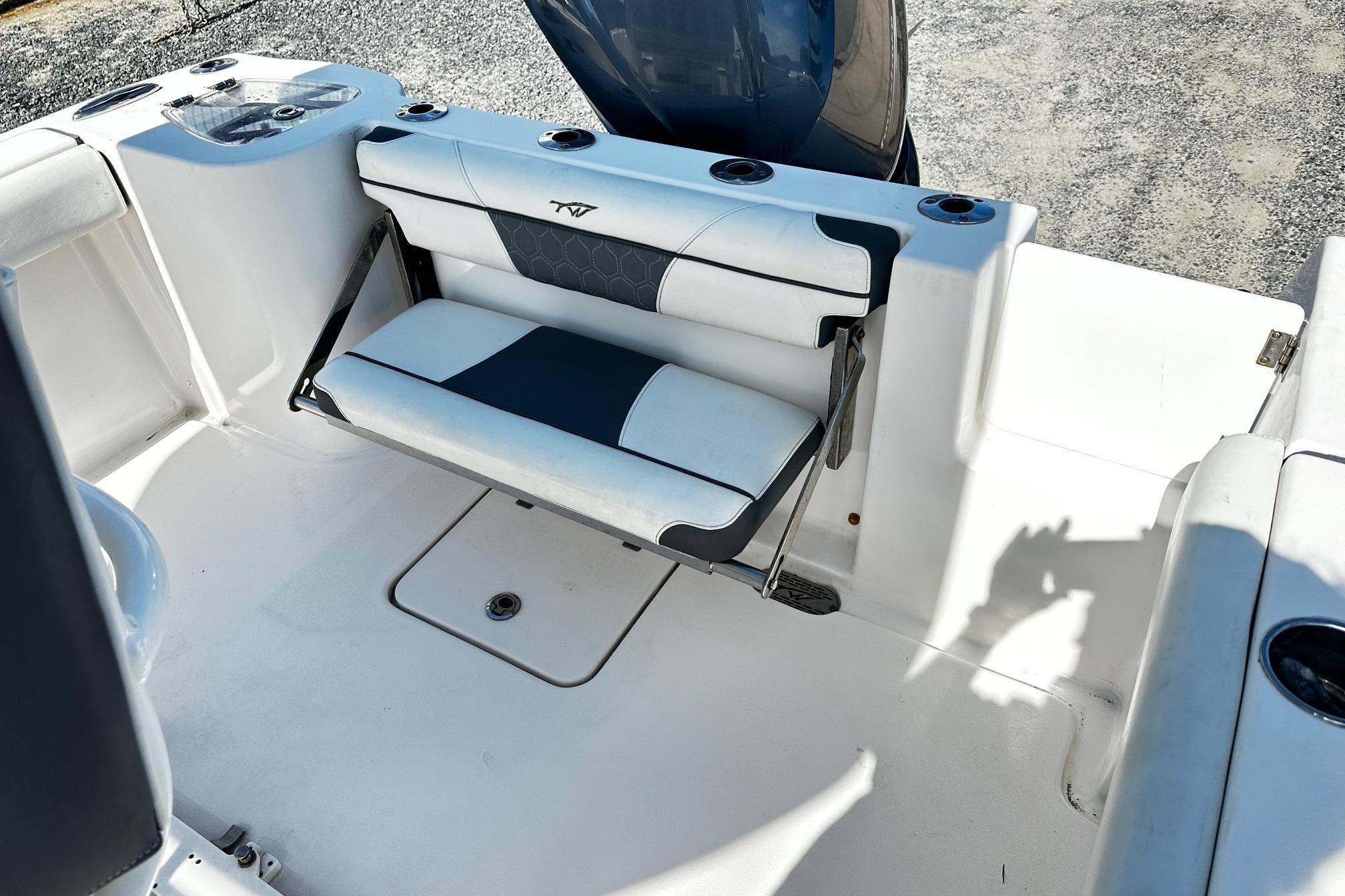2020 Tidewater 230 CC Adventure boat interior with foldable seating and cup holders.