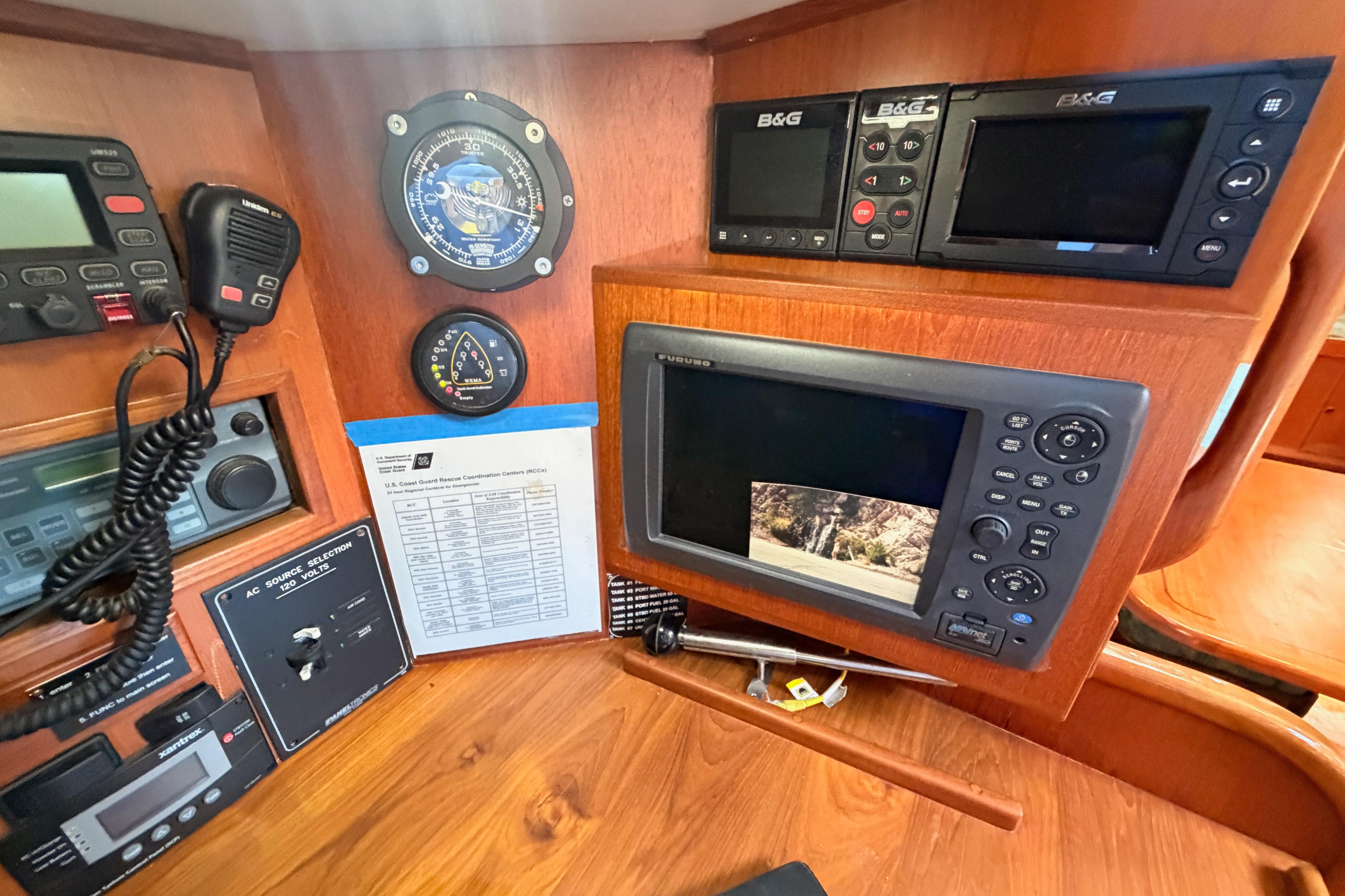 Navigation equipment and controls inside a 1991 Hylas 51 yacht cabin.