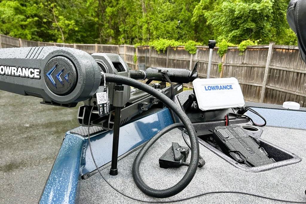 2026 Ranger RT188P boat with Lowrance equipment, wet deck, and wooden fence background.