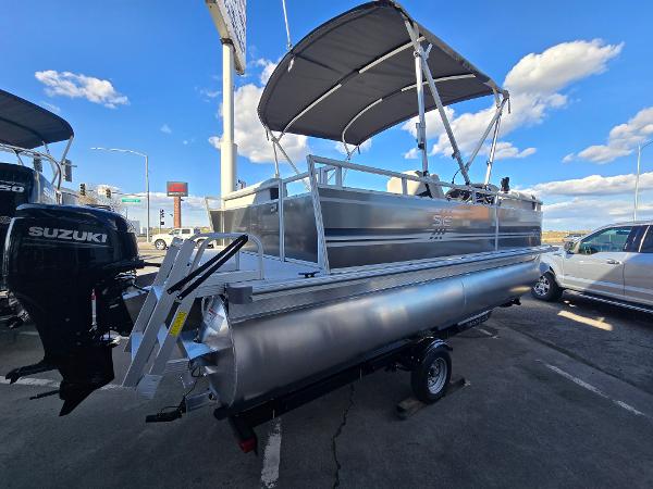 2025 Berkshire 20 CL pontoon boat with canopy, parked outdoors under blue sky.