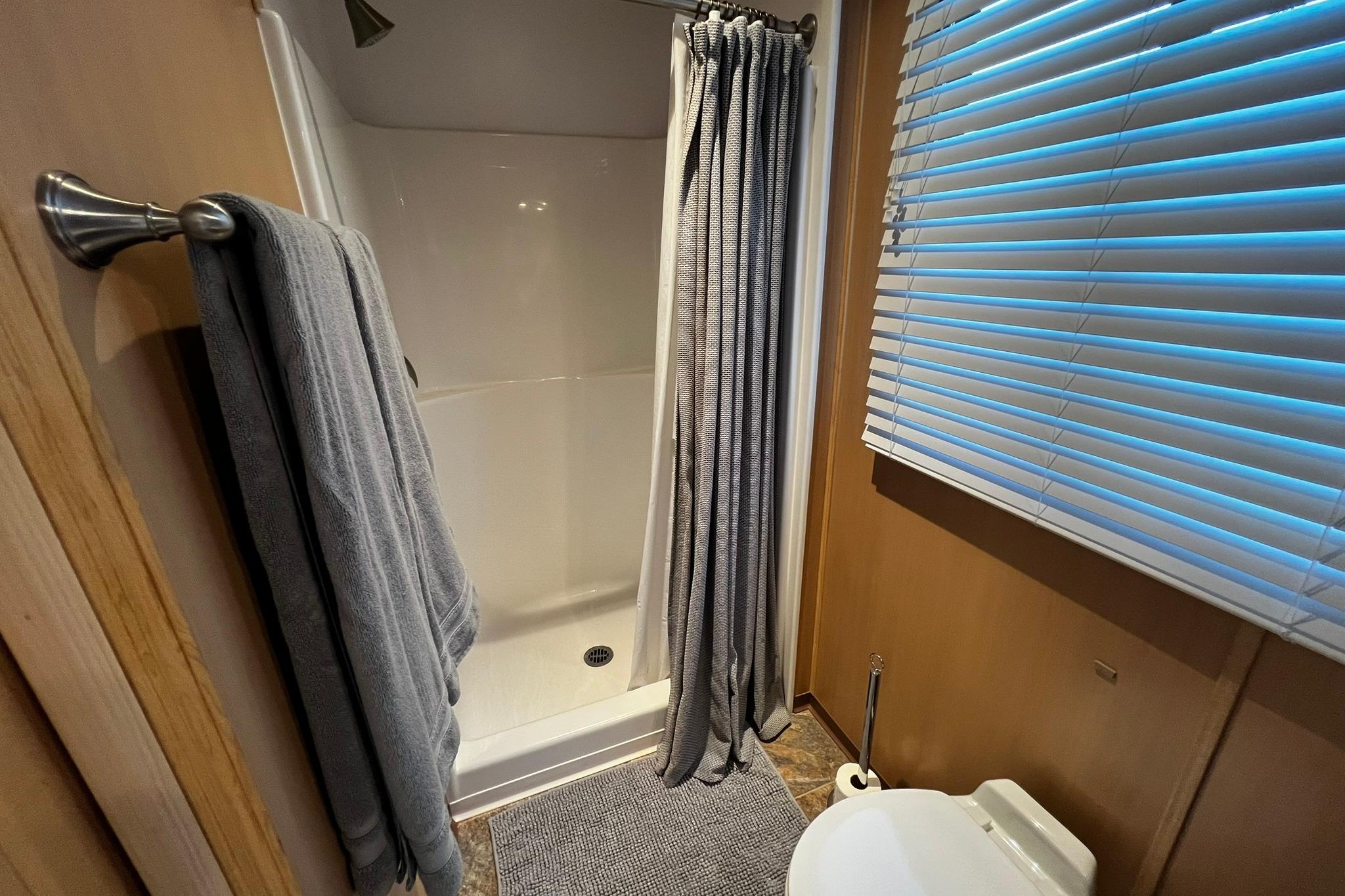 Bathroom interior of 2010 Skipperliner 480 Flybridge with shower and toilet.